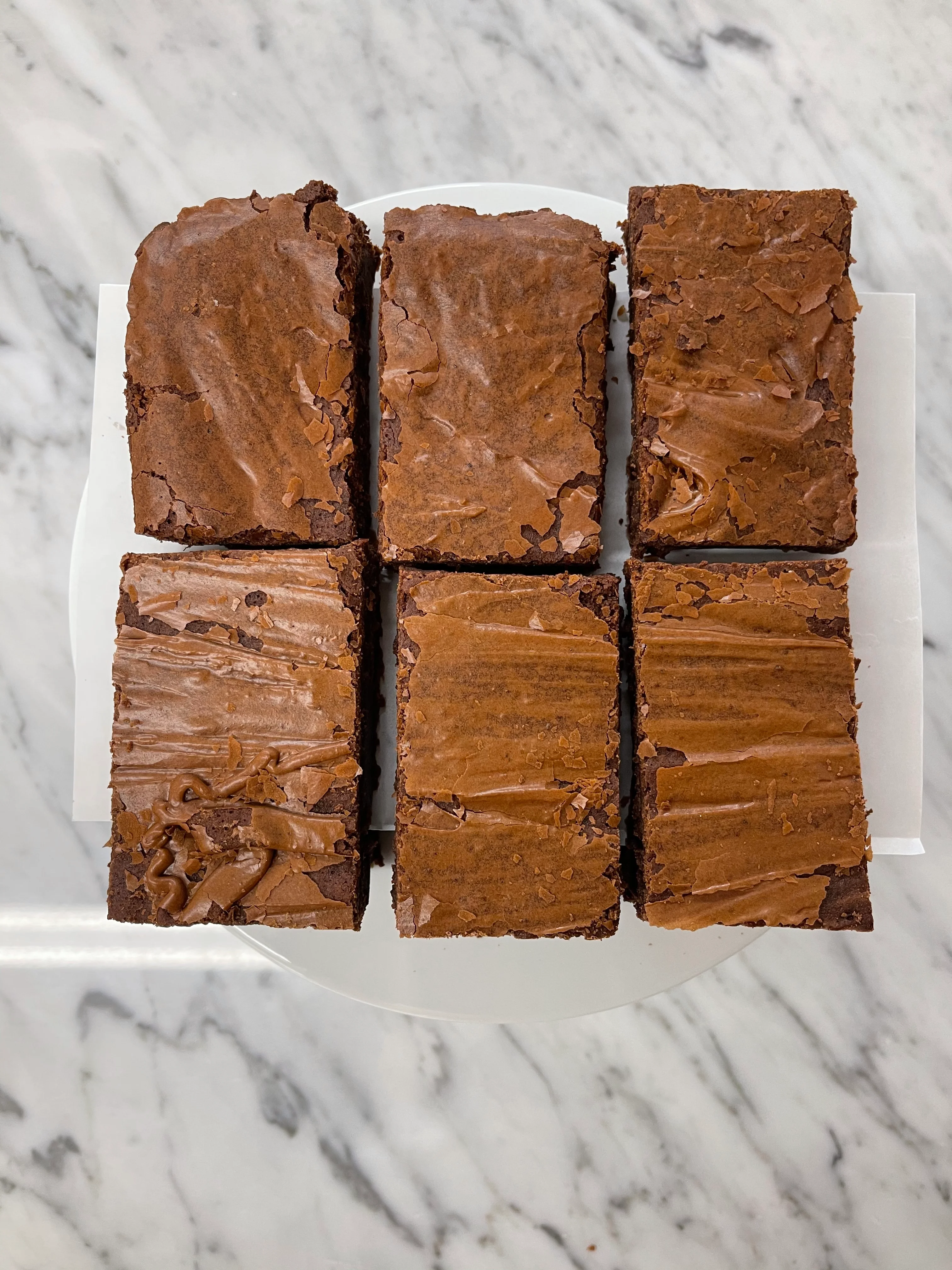 Decadent chocolate brownies on a white plate