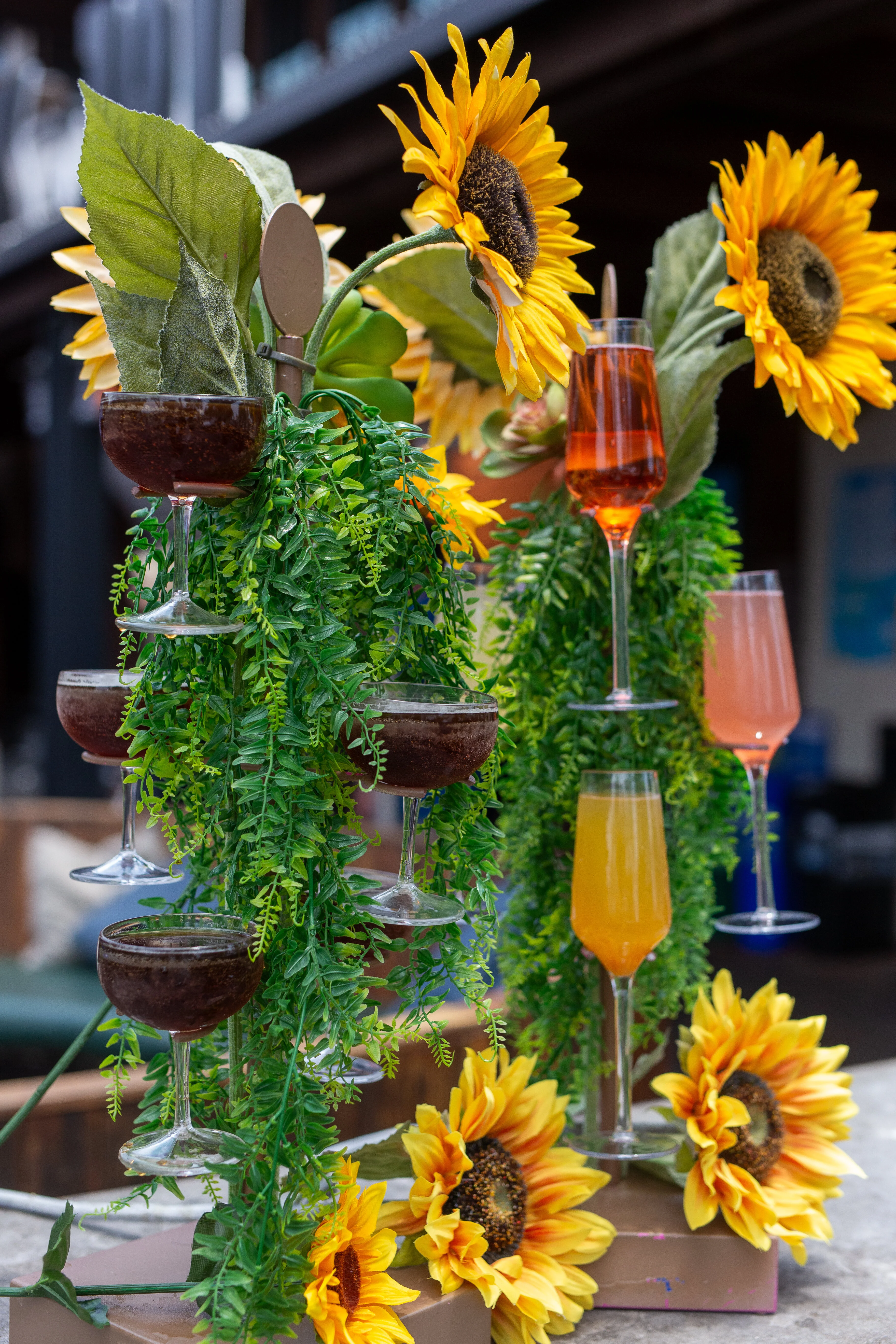 Colorful cocktail display with sunflowers and greenery