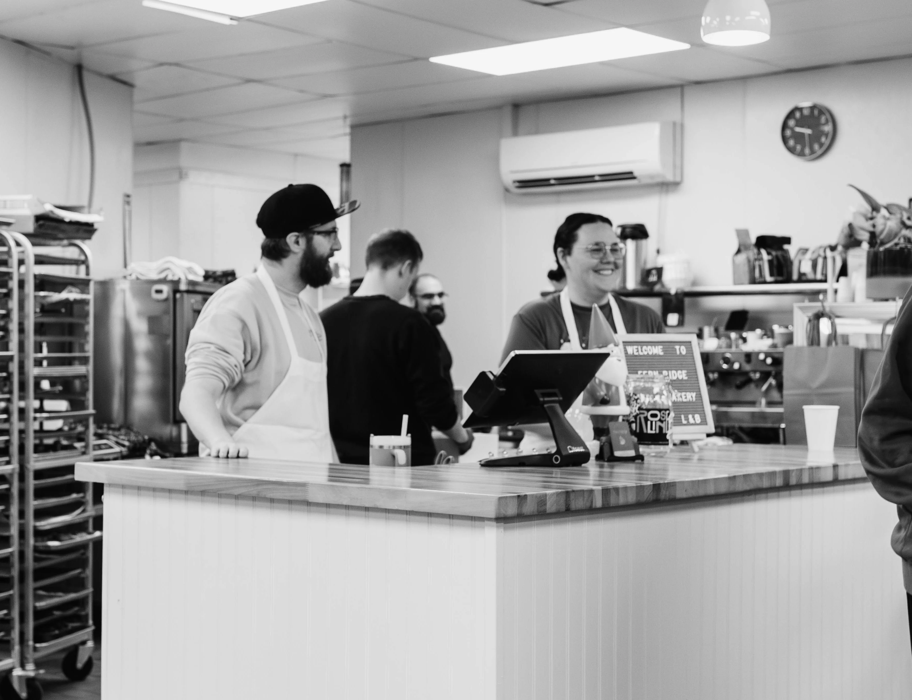 Friendly staff at a cozy bakery counter