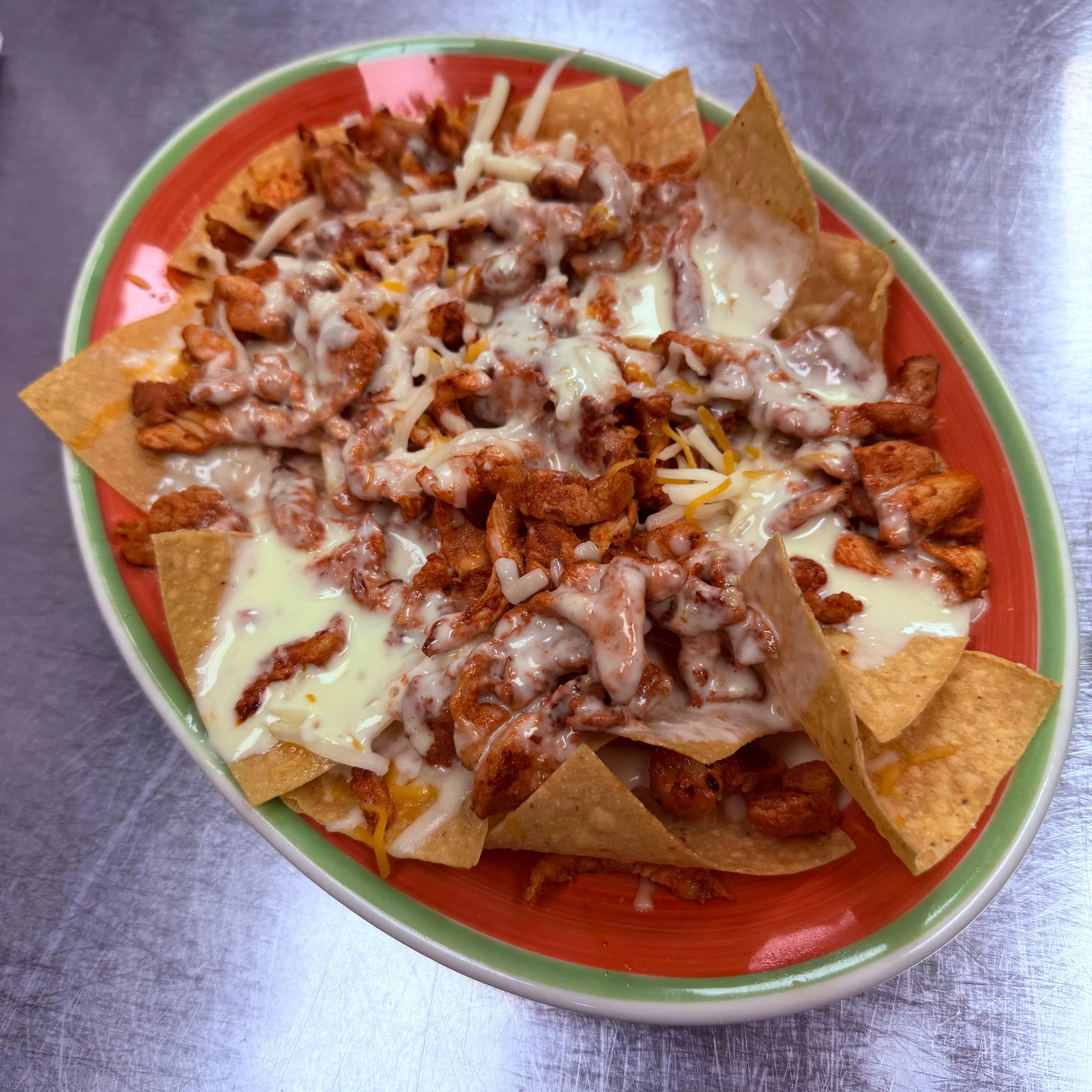 Loaded chicken nachos with cheese and toppings