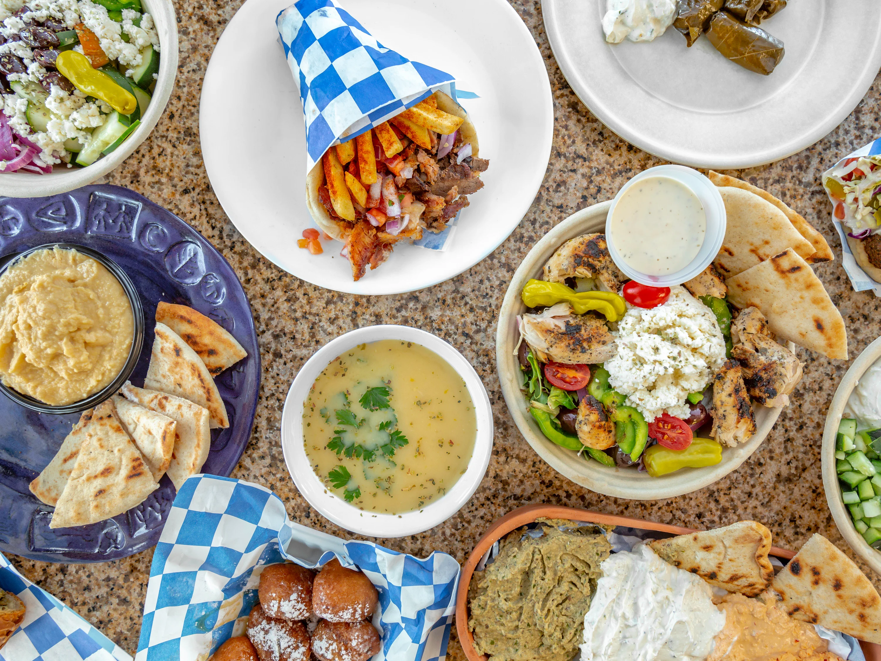 Mediterranean platter with gyros, hummus, and fresh salads