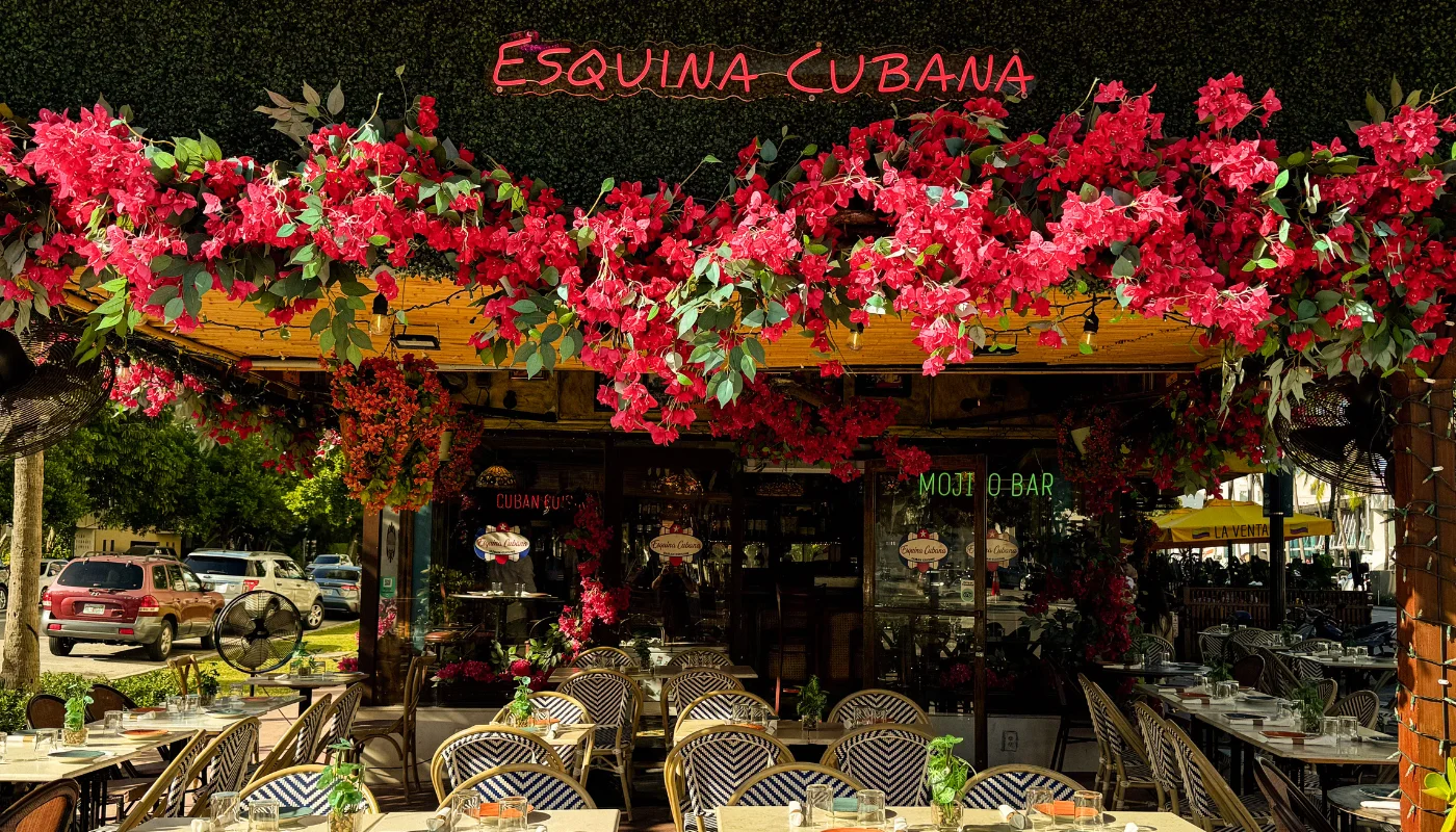 Charming Cuban restaurant exterior adorned with vibrant flowers