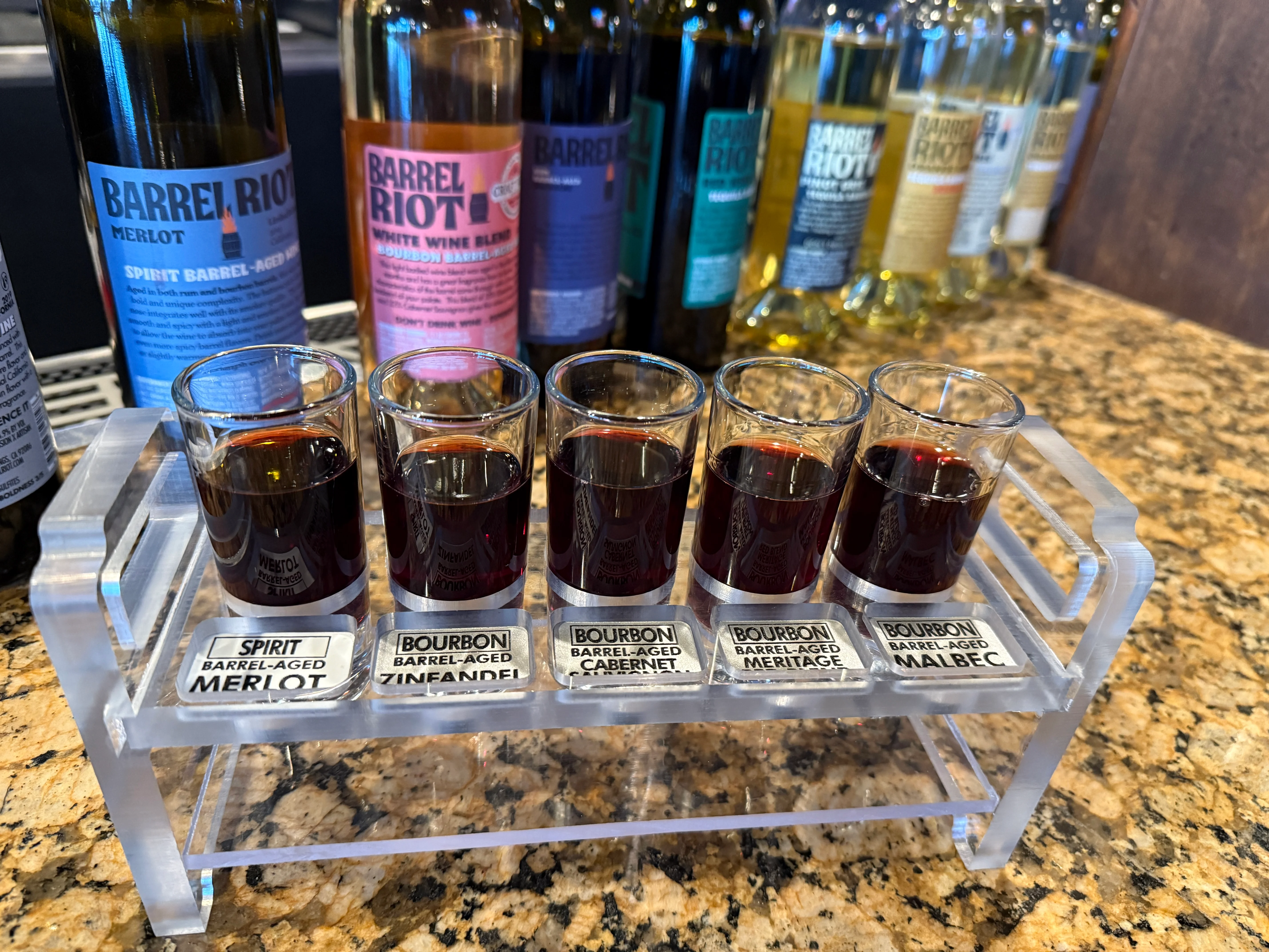 Tasting flight of barrel-aged wines at a modern bar