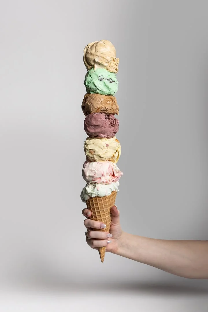 Colorful ice cream cone with multiple scoops stacked high