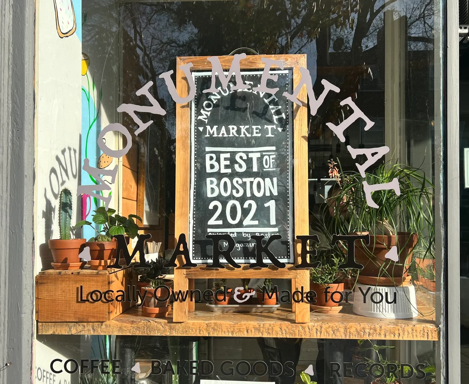 Charming market window showcasing local goods and awards