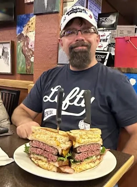 Giant cheeseburger sandwich served in a casual restaurant