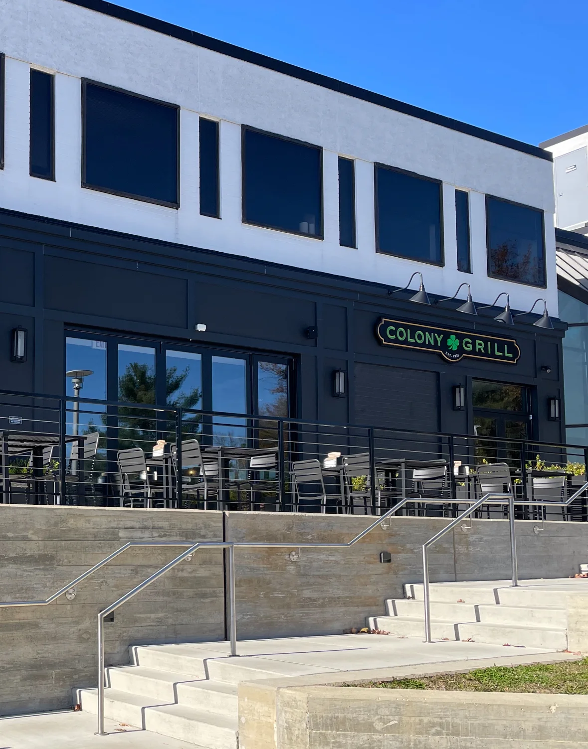 Exterior view of Colony Grill restaurant with outdoor seating