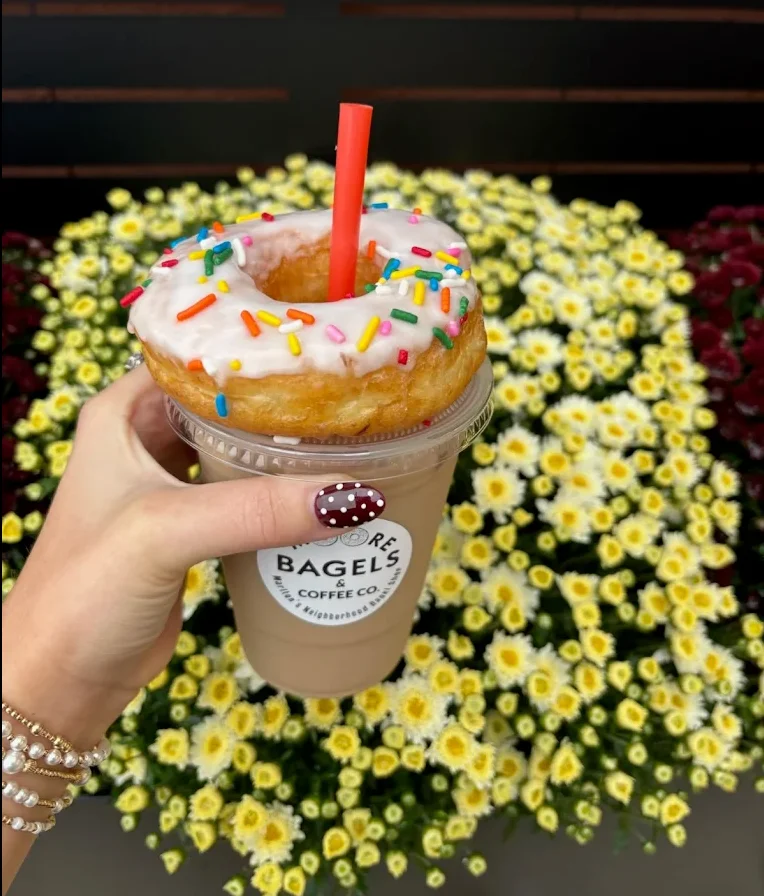 A logo design featuring the name 'Moore Bagels & Coffee Co.' with a tagline indicating it is a neighborhood bagel shop.