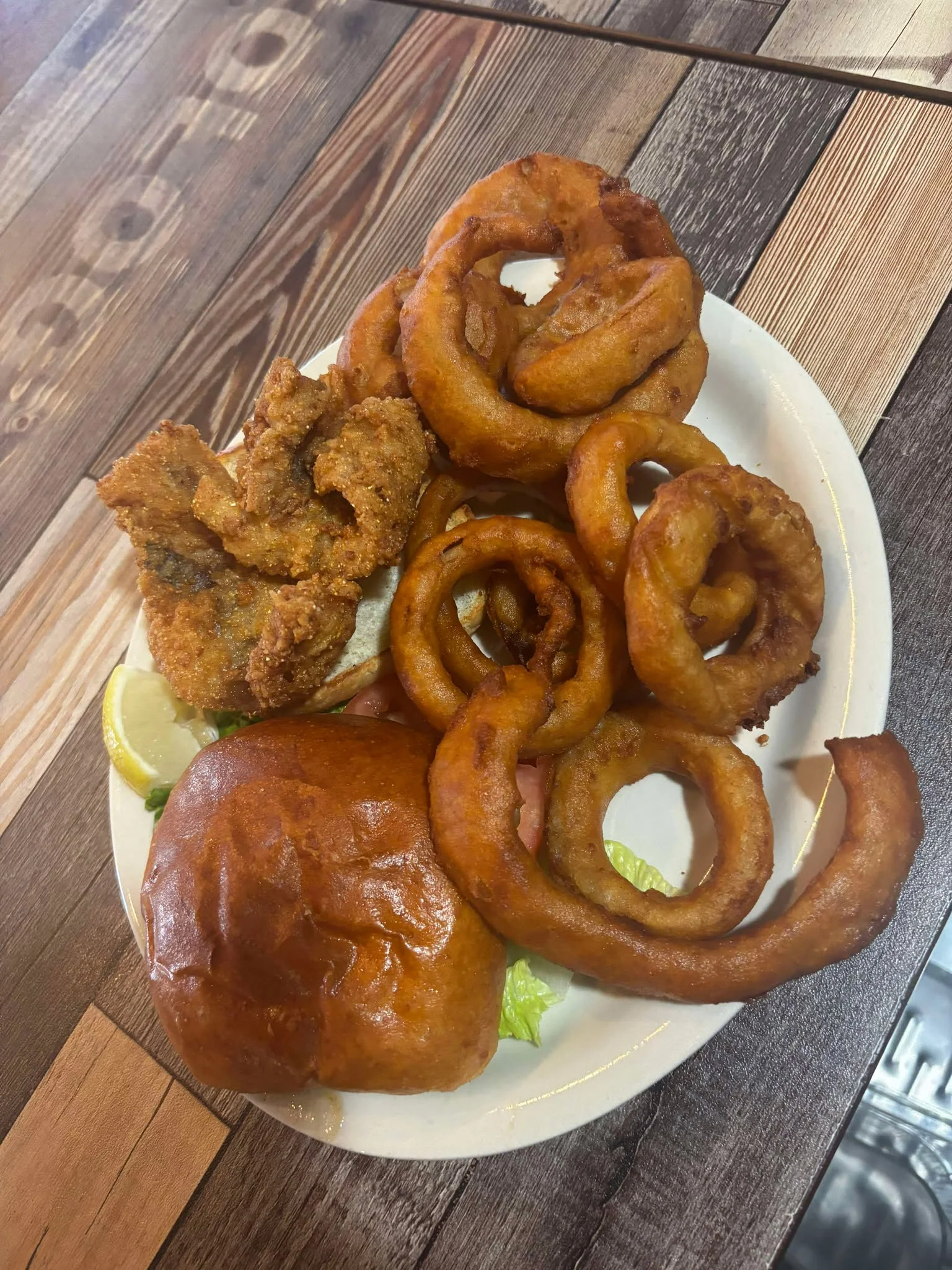 Southern fried catfish with onion rings and a bun