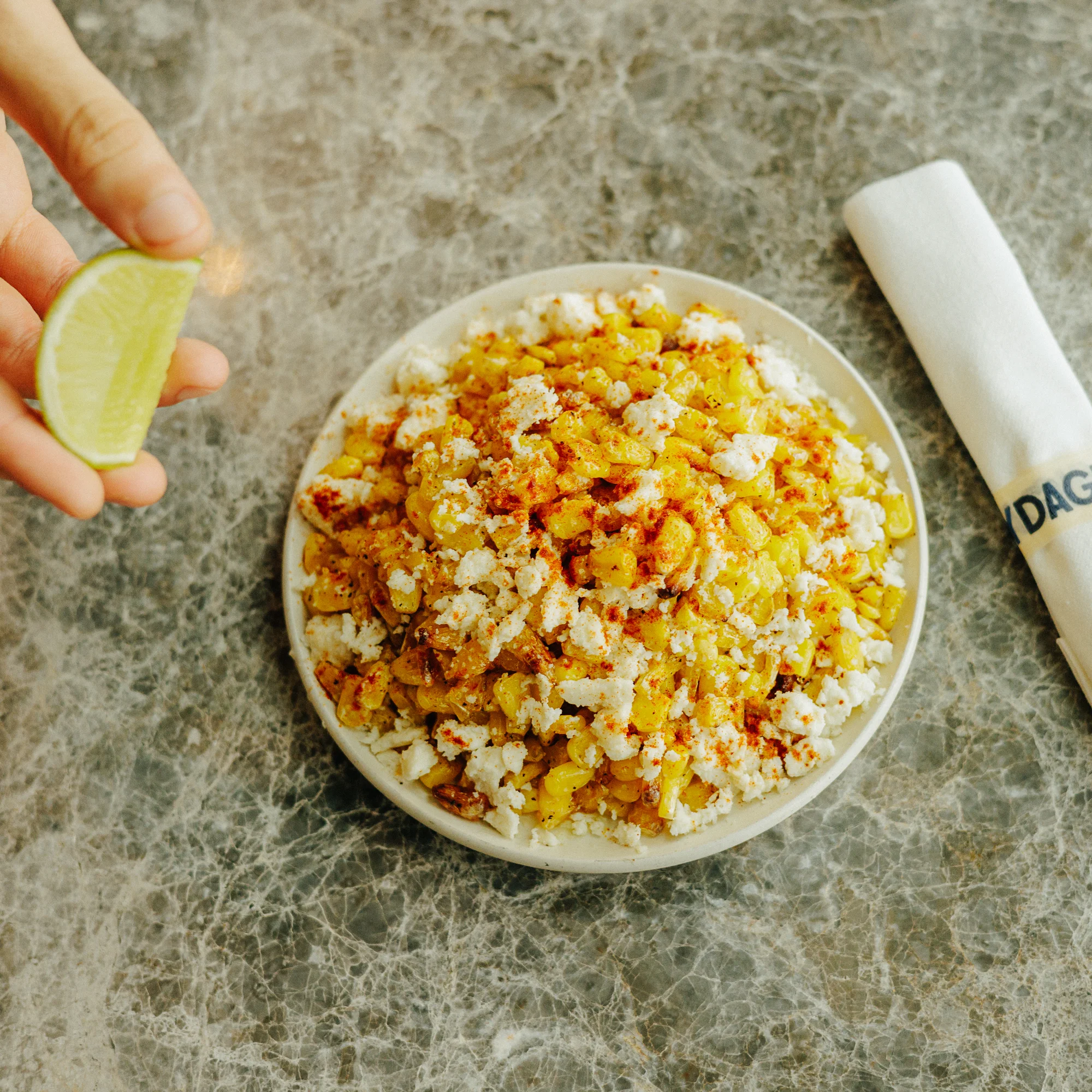 Mexican elote bowl topped with cheese and spices