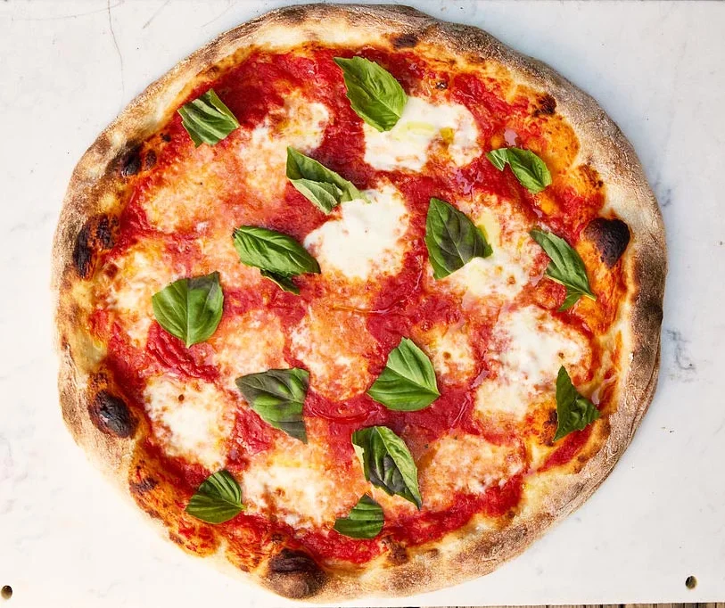 Margherita pizza with fresh basil and tomato sauce