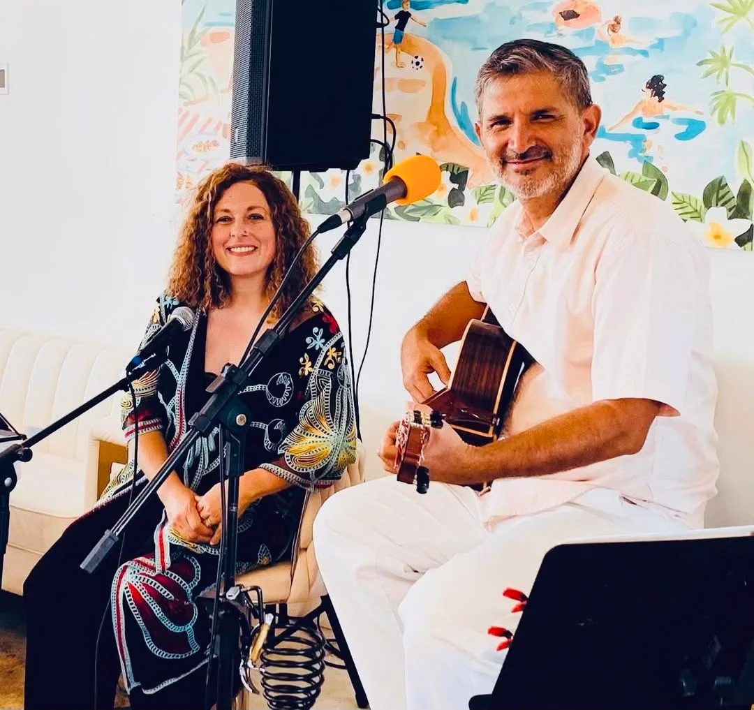 Live music performance with guitar and vocals in a cozy setting