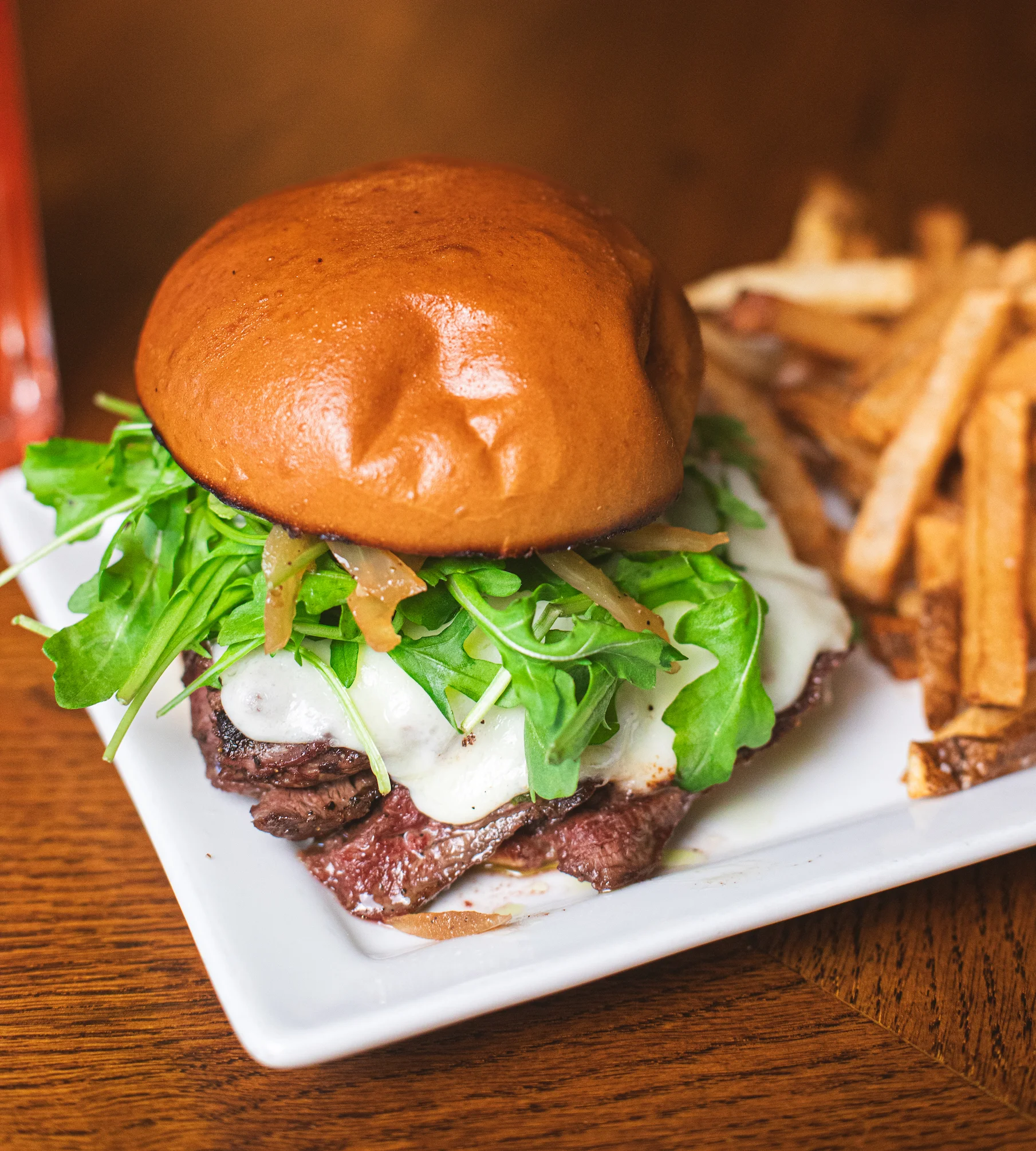 Juicy steak sandwich with arugula and melted cheese