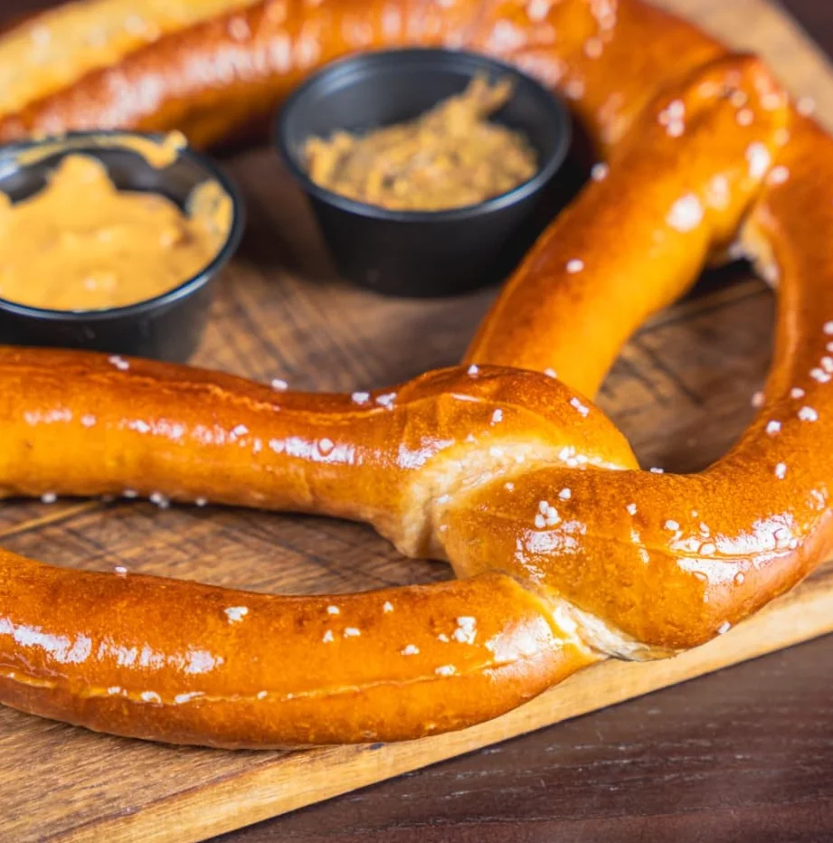 Soft German pretzel served with dipping sauces