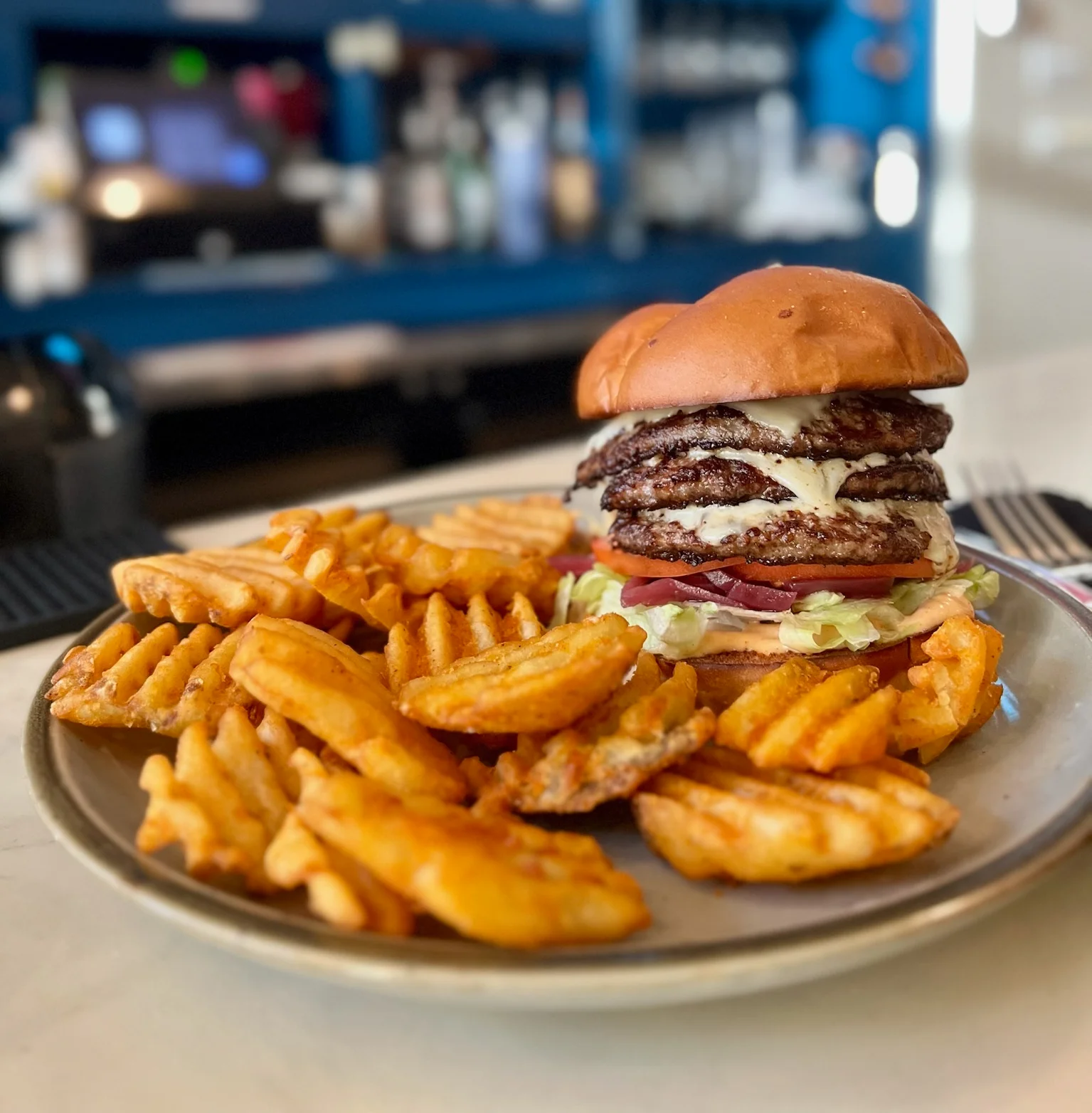 Juicy American cheeseburger with waffle fries