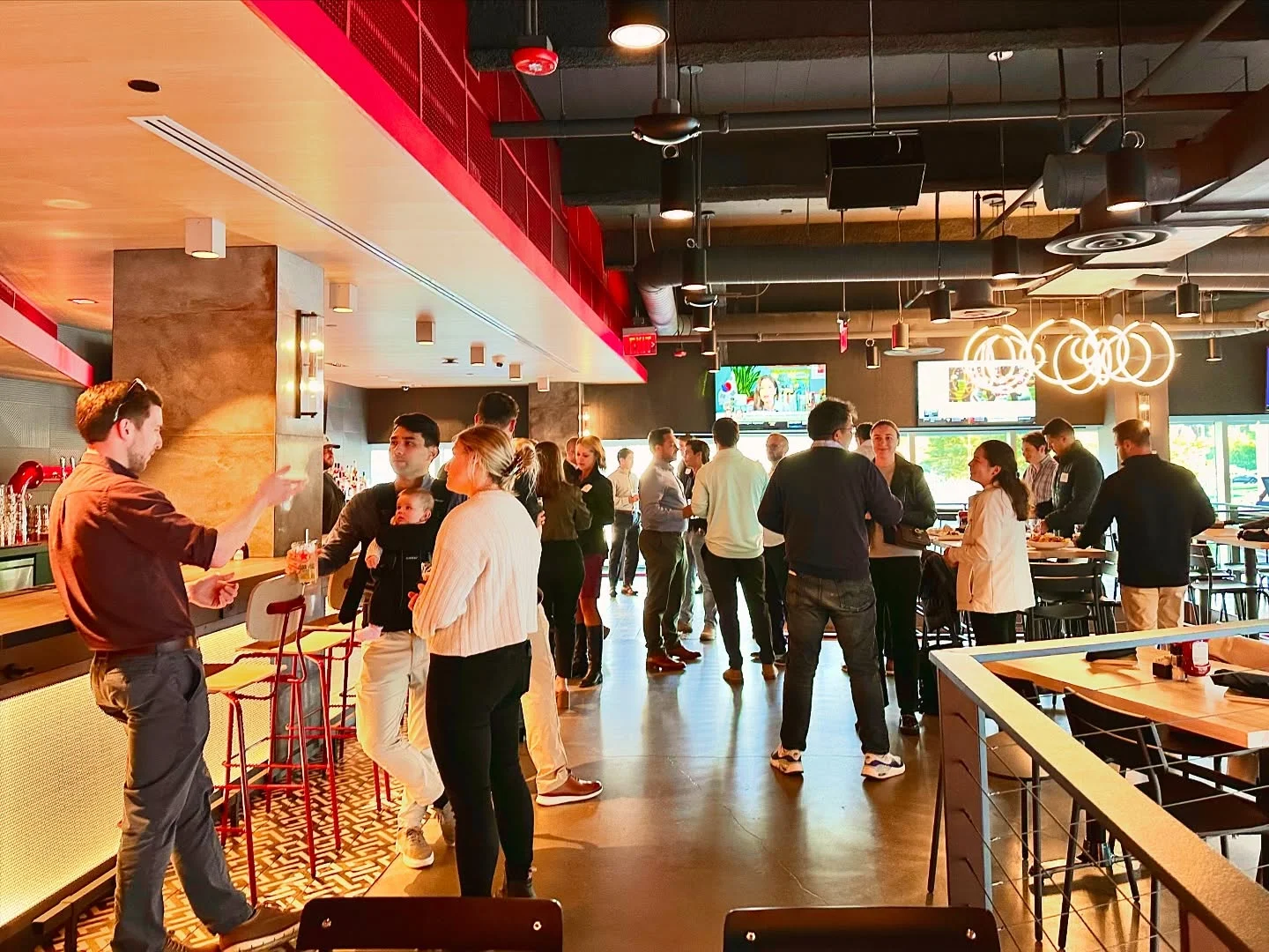 Modern restaurant interior with patrons socializing and enjoying drinks