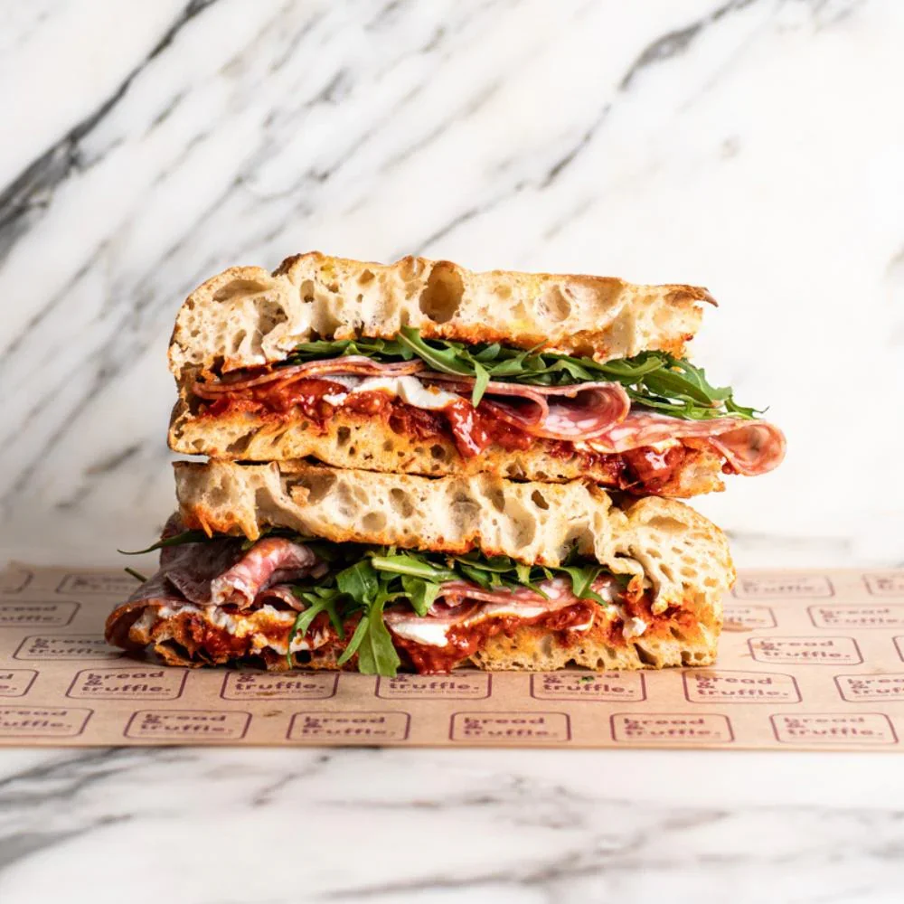 Italian panini sandwich with cured meats and arugula