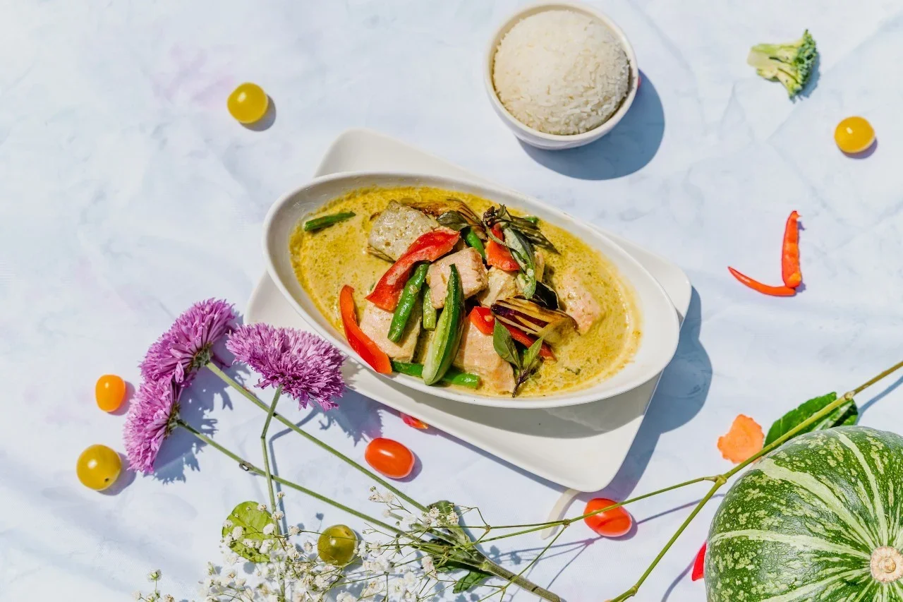 Thai green curry with fish and vegetables served with rice