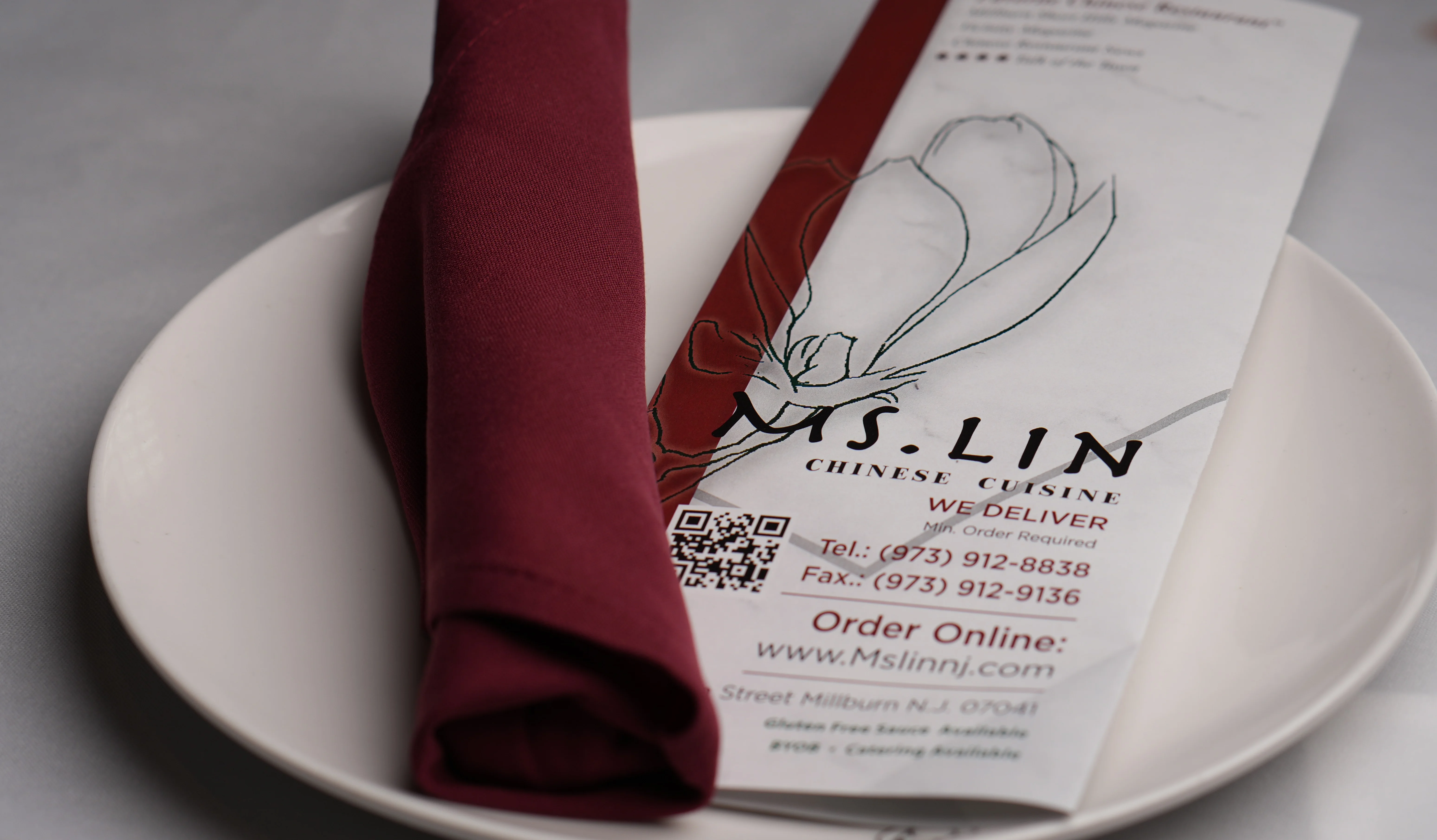 Chinese restaurant menu with a red napkin on a white plate