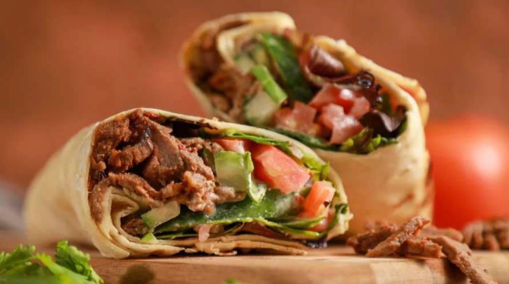 Delicious Mexican burrito filled with beef and fresh vegetables