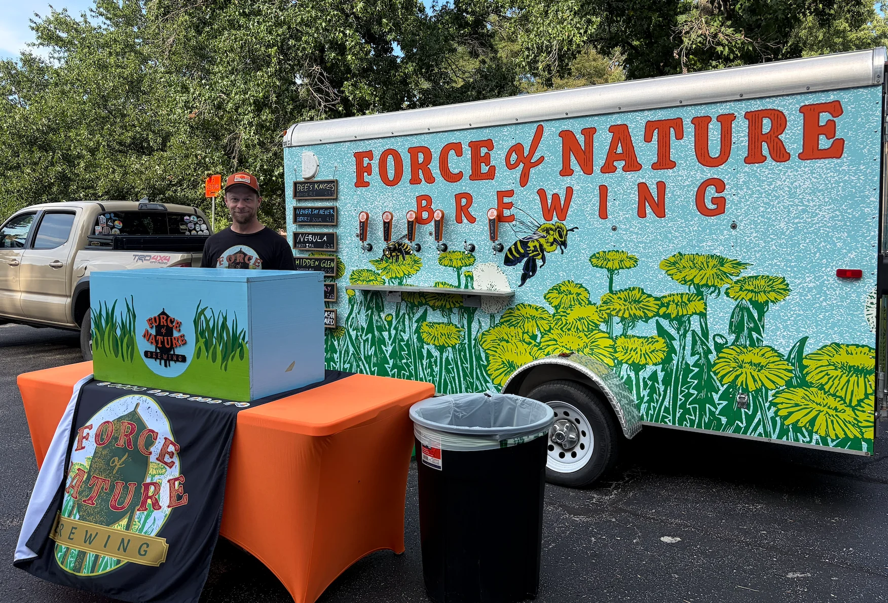 Colorful Force of Nature Brewing tap trailer at an outdoor beer event