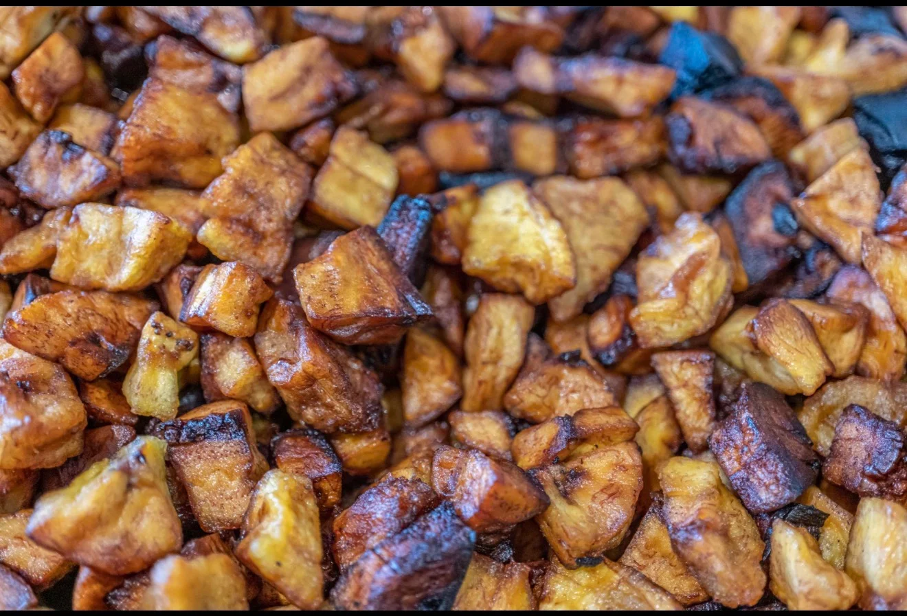 A close-up image of diced, golden-brown fried plantains.