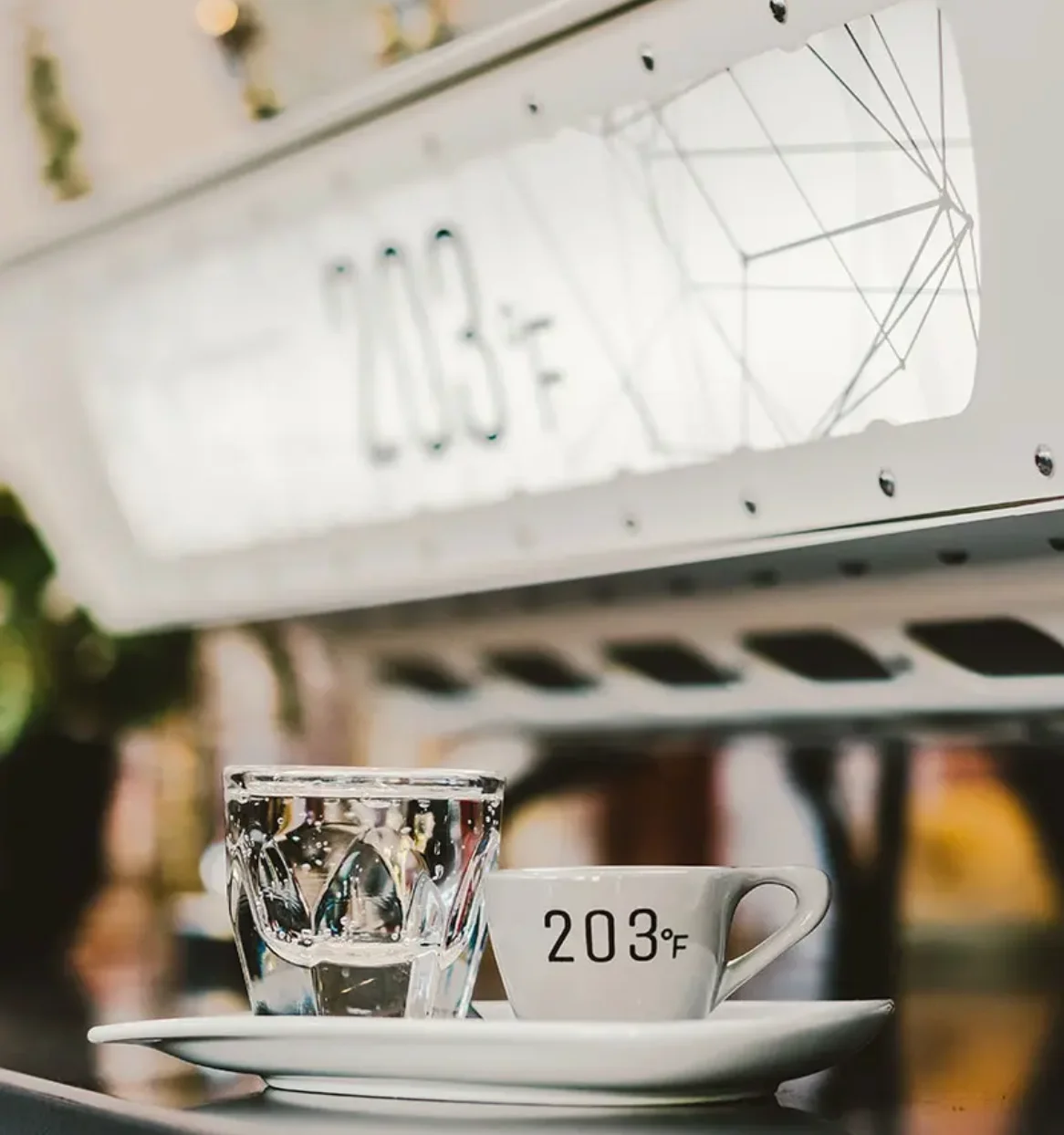 Coffee cup and glass of water on a modern café counter