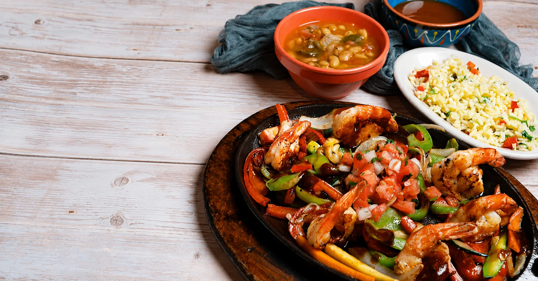 Sizzling shrimp fajitas served with rice and soup