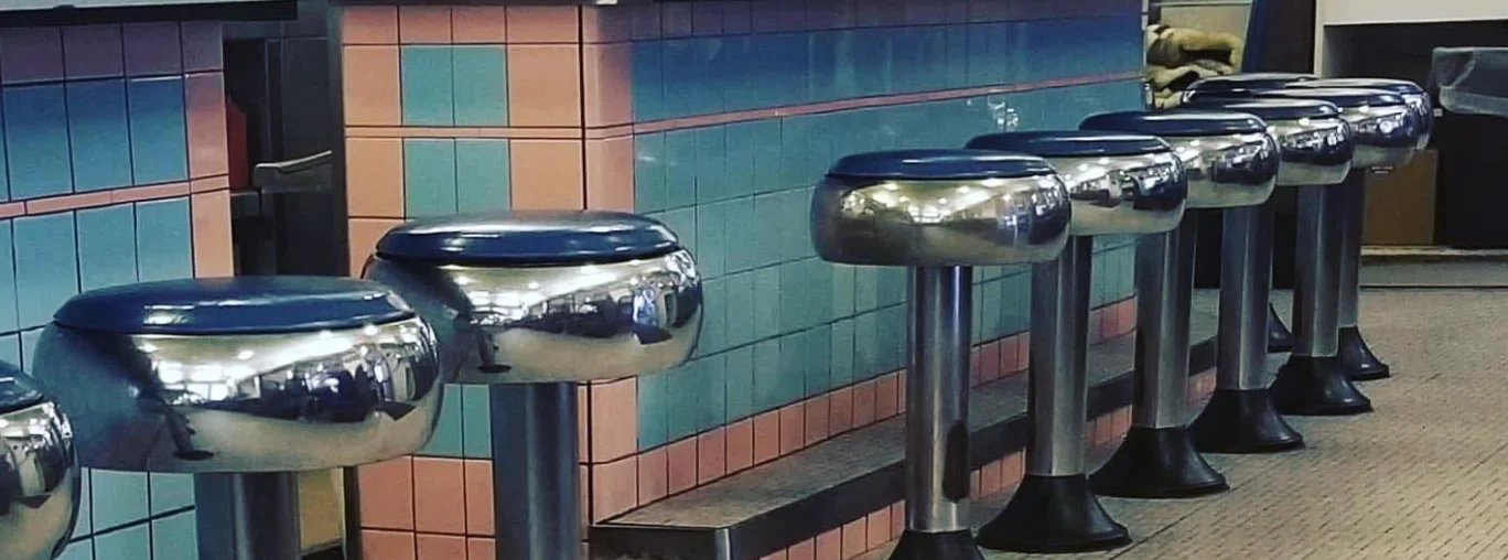 Retro diner bar stools with colorful tiled backdrop