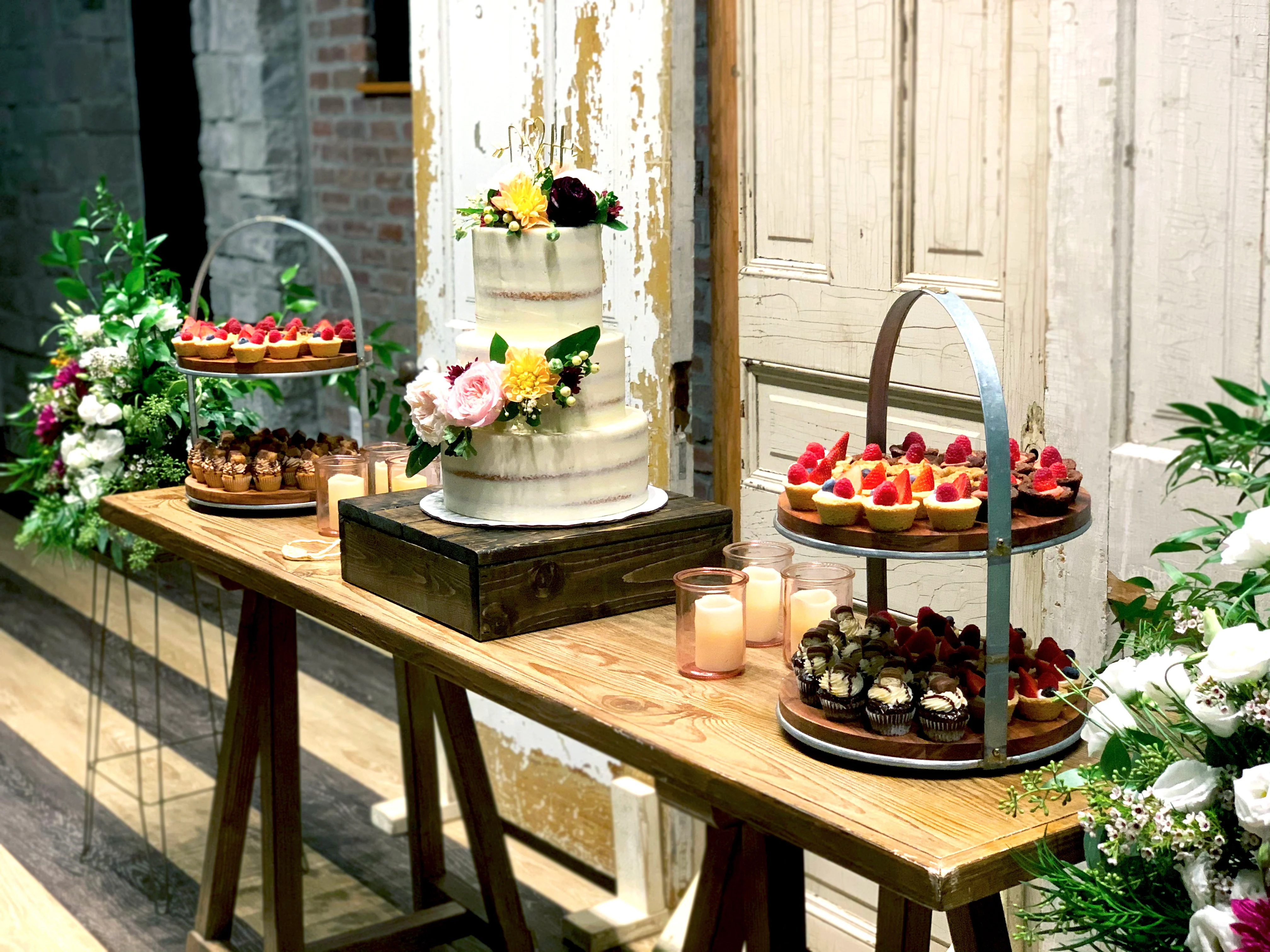 Elegant dessert table with wedding cake and assorted pastries