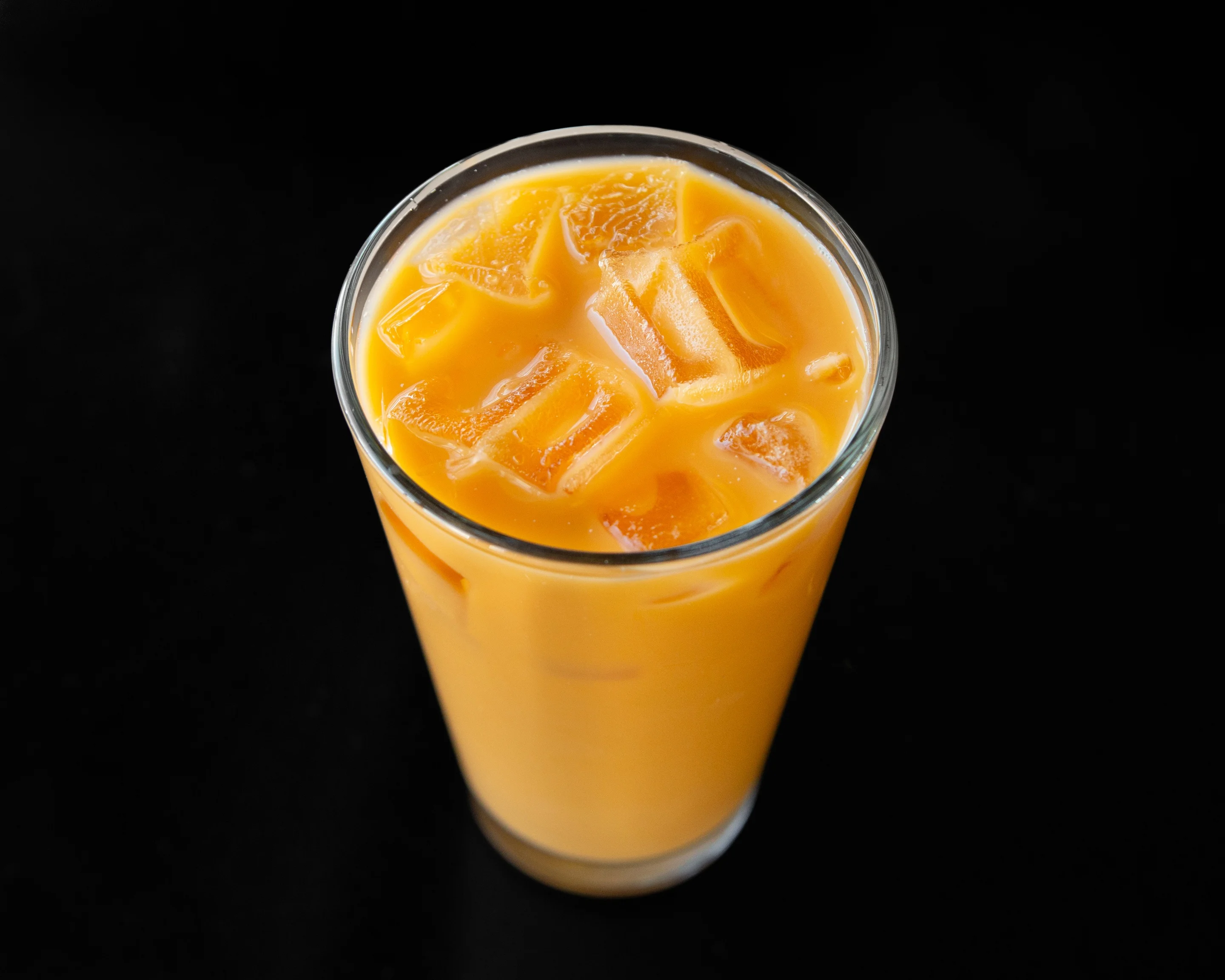 Refreshing Thai iced tea with ice cubes in a glass