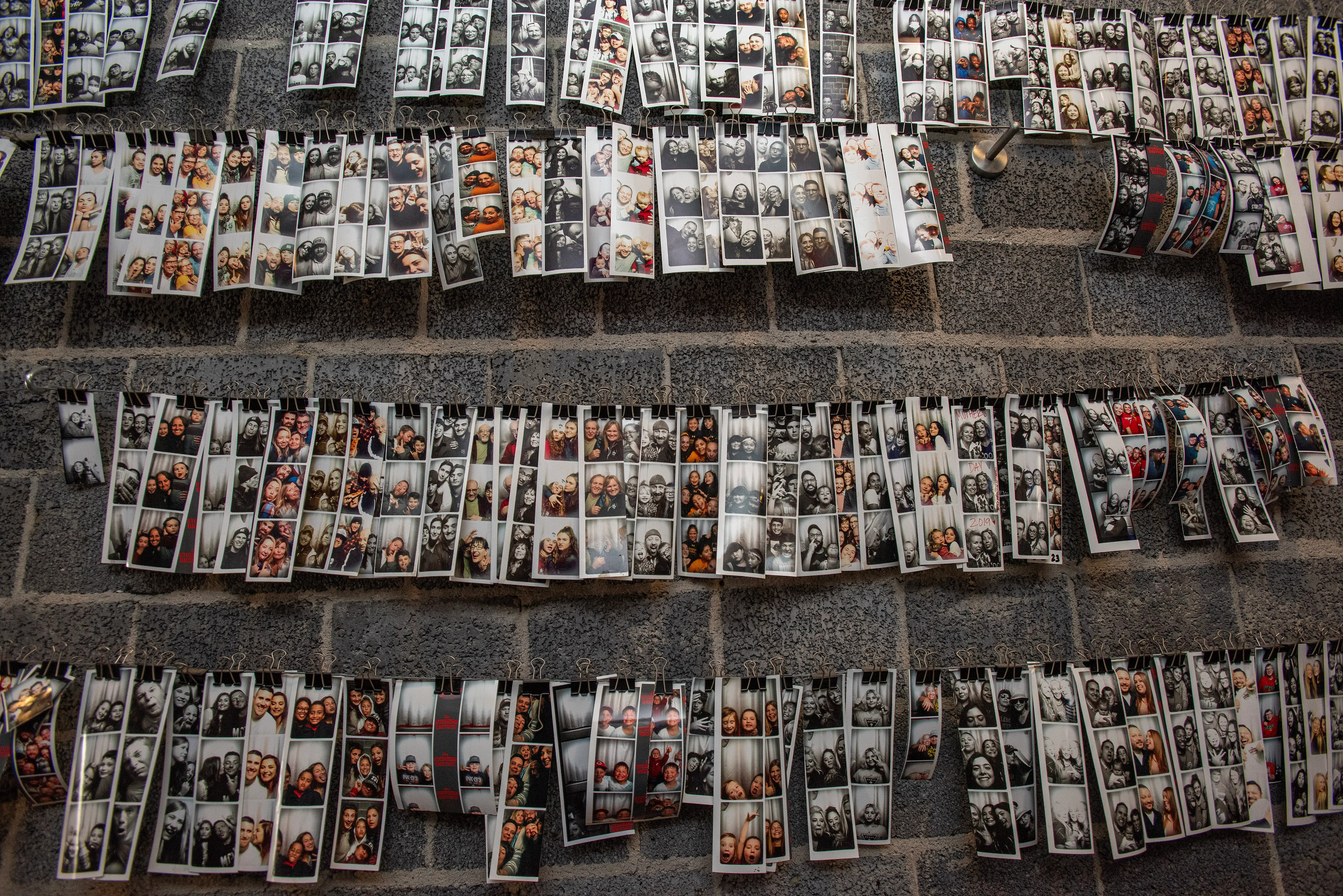 Wall of photo strips showcasing joyful moments