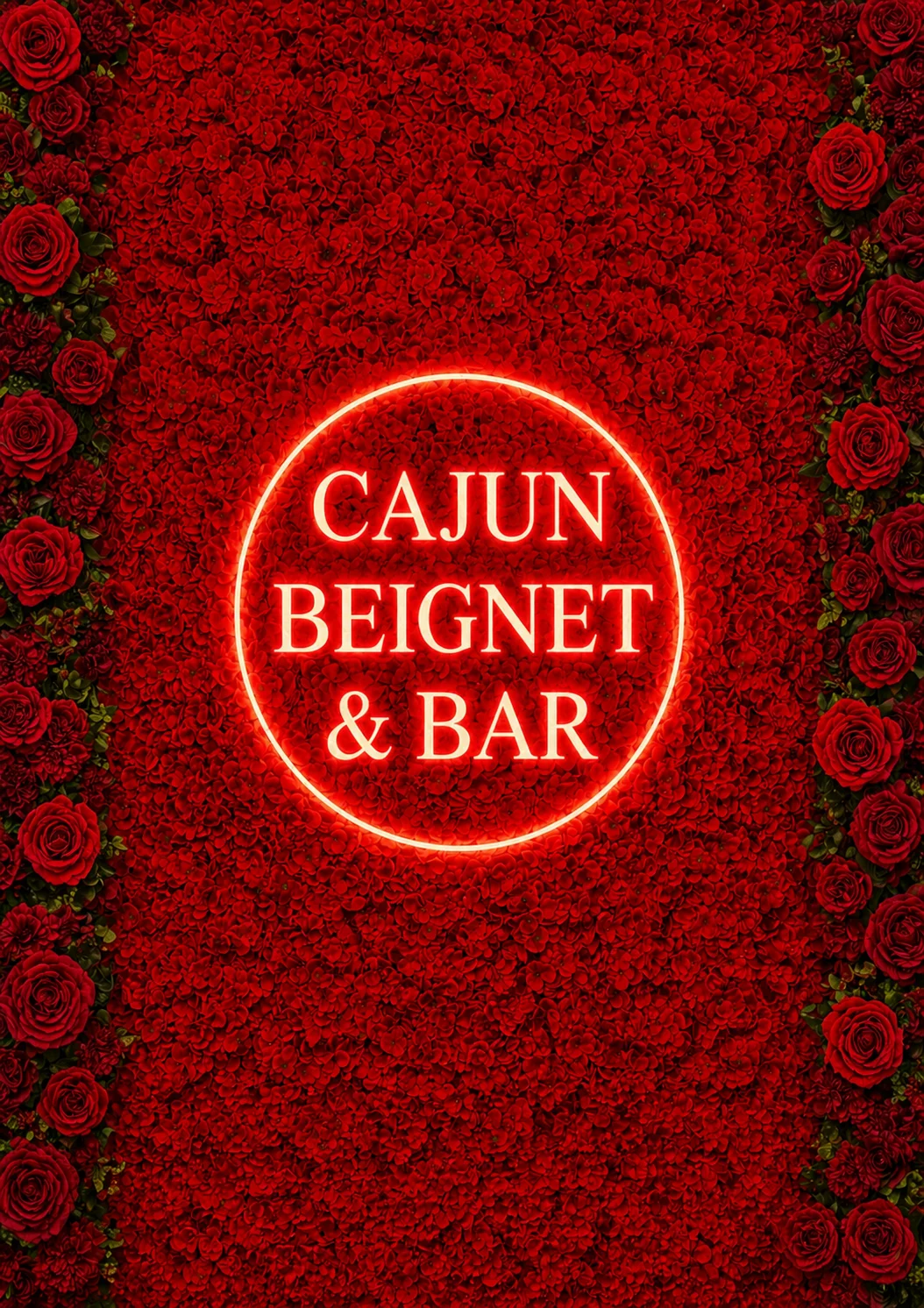 A vibrant floral wall made of red roses, featuring a circular neon sign with the text 'CAJUN BEIGNET & BAR' in the center.