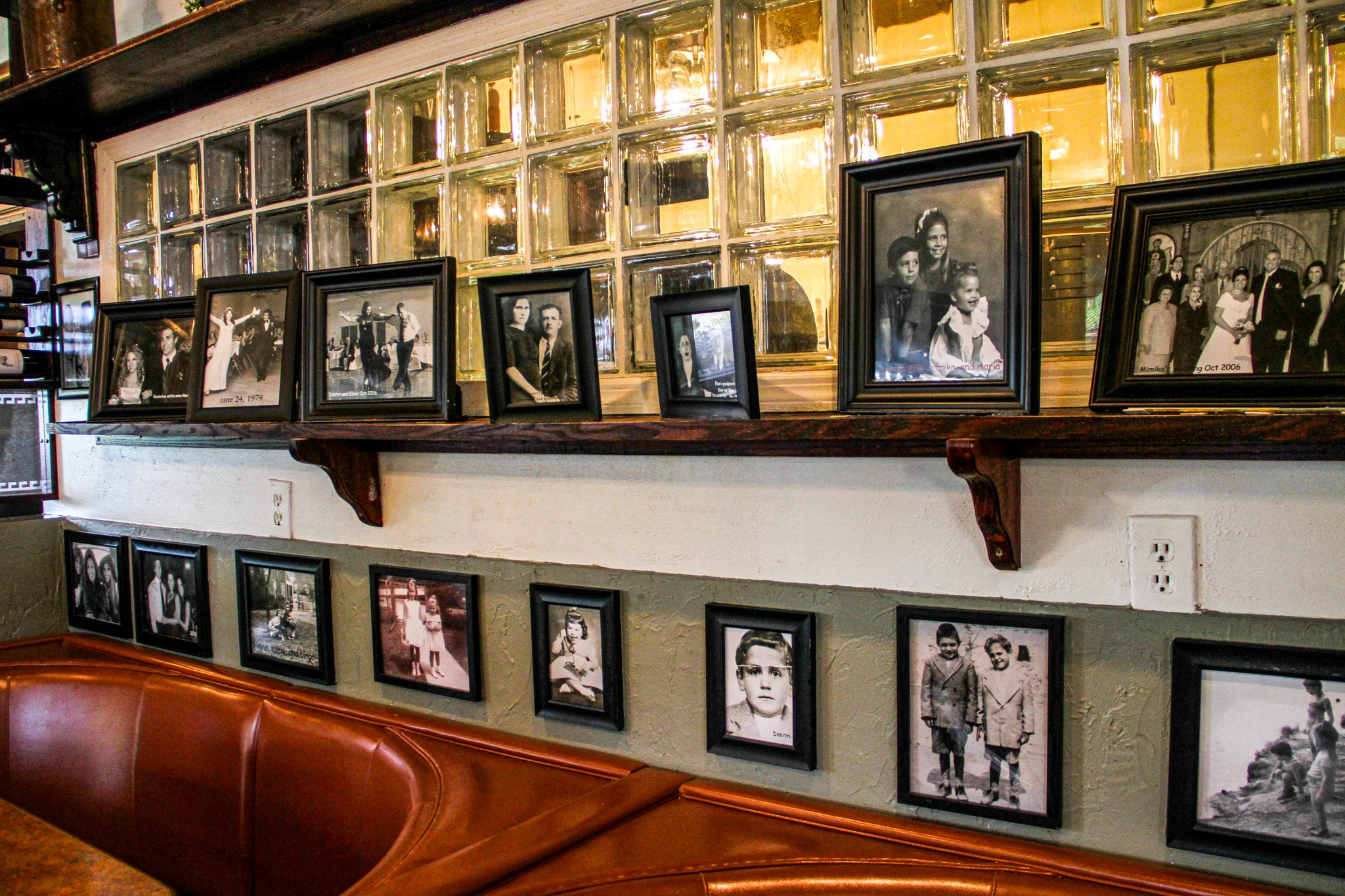Framed black and white photos displayed on a restaurant wall.