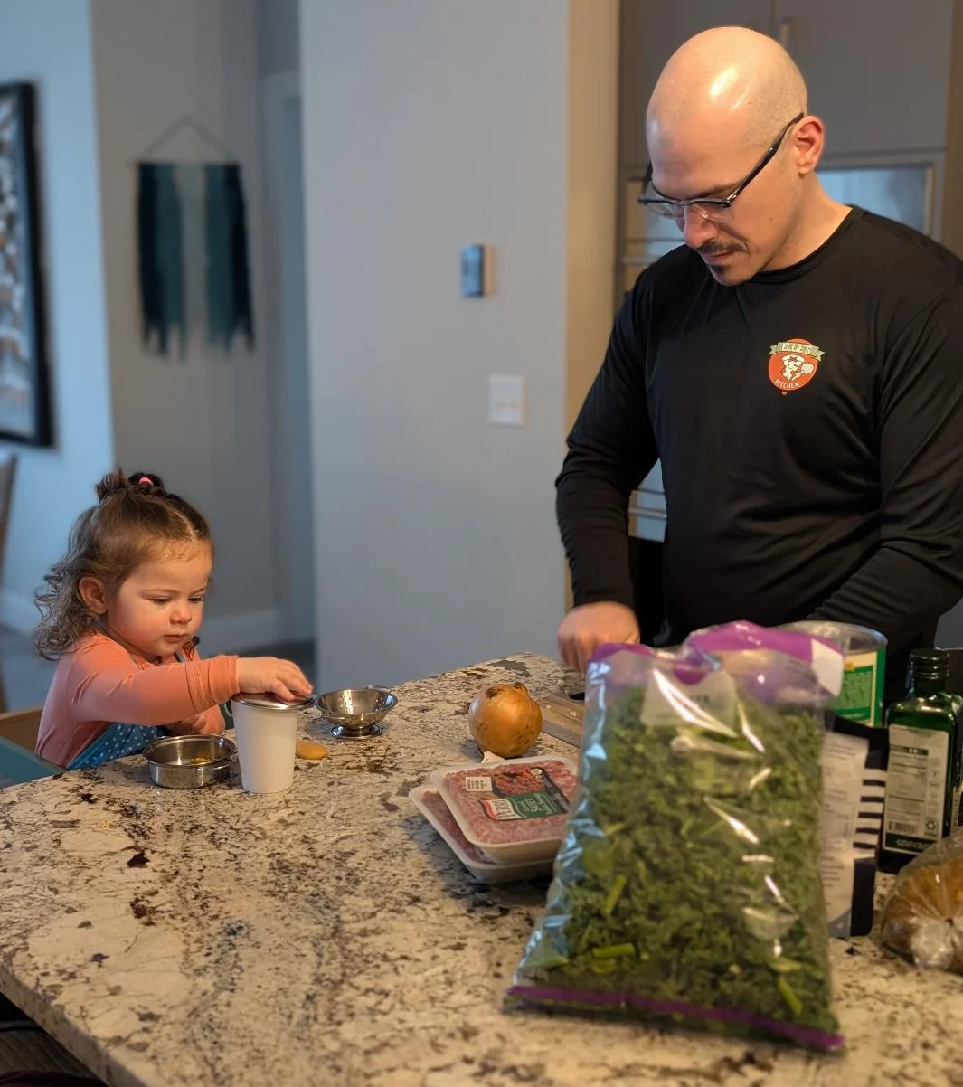 Father and daughter cooking together in a modern kitchen