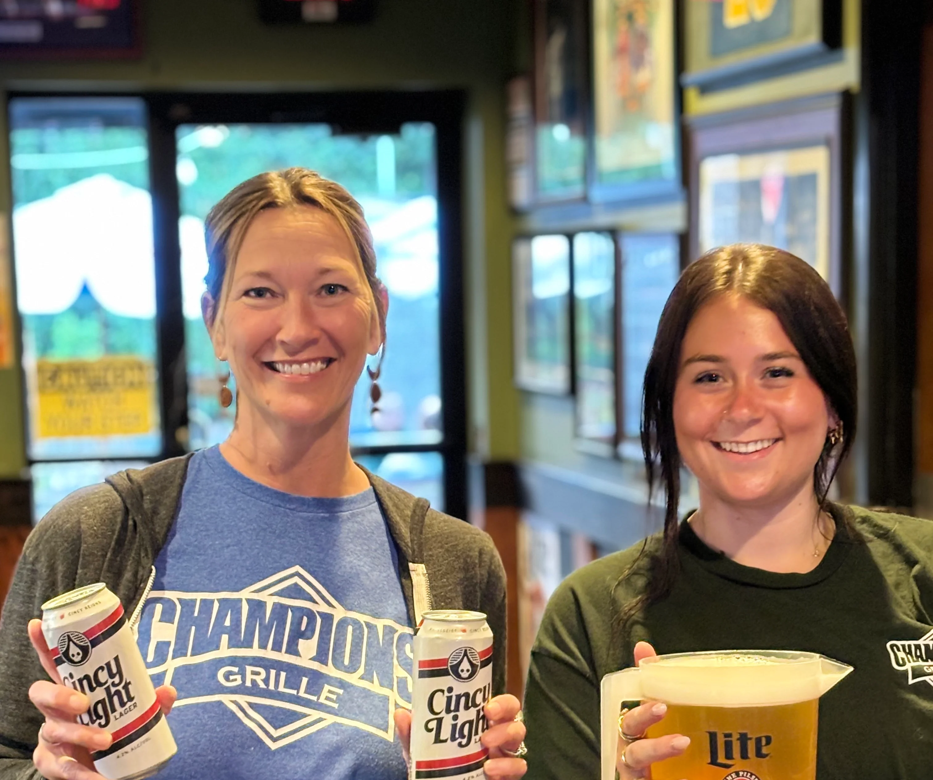 Friendly servers showcasing drinks at a lively restaurant