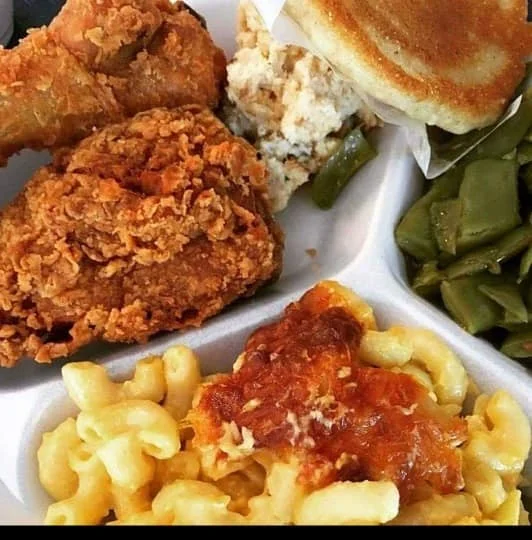 Southern fried chicken with sides in a takeout container