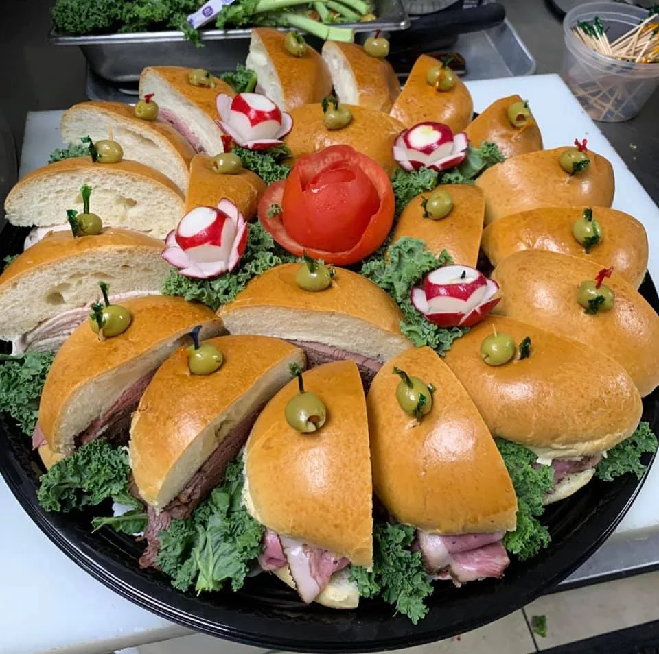 Artfully arranged sandwich platter with decorative garnishes