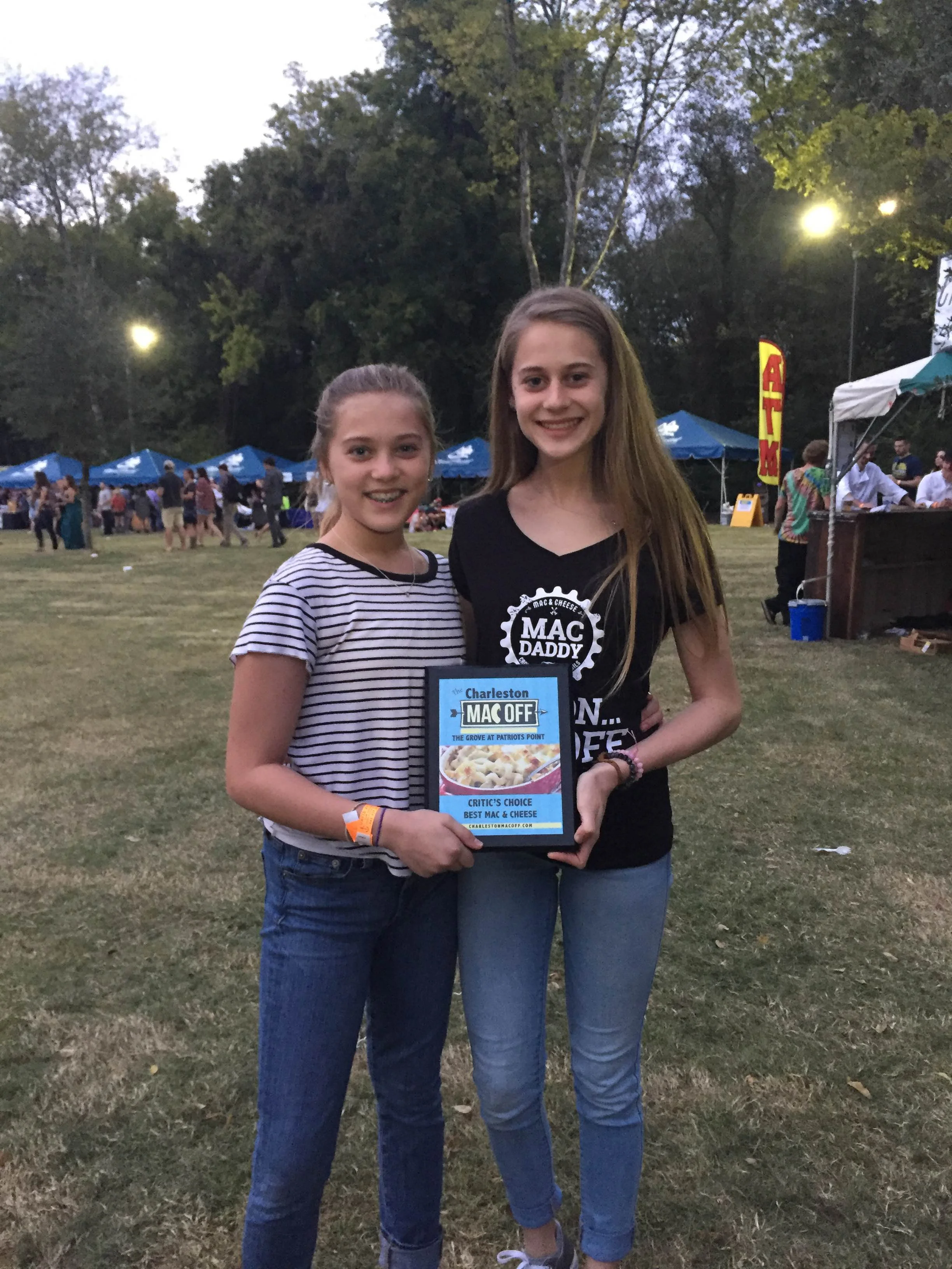 Two girls holding a award at a food festival