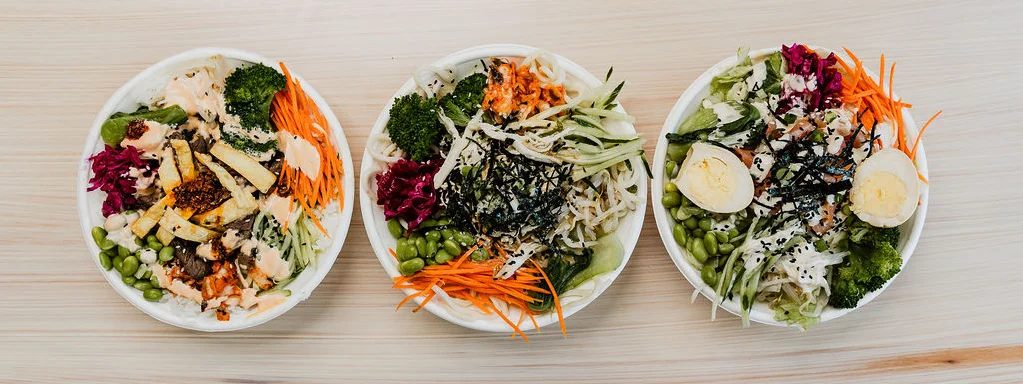 three bento bowls with different meats and toppings