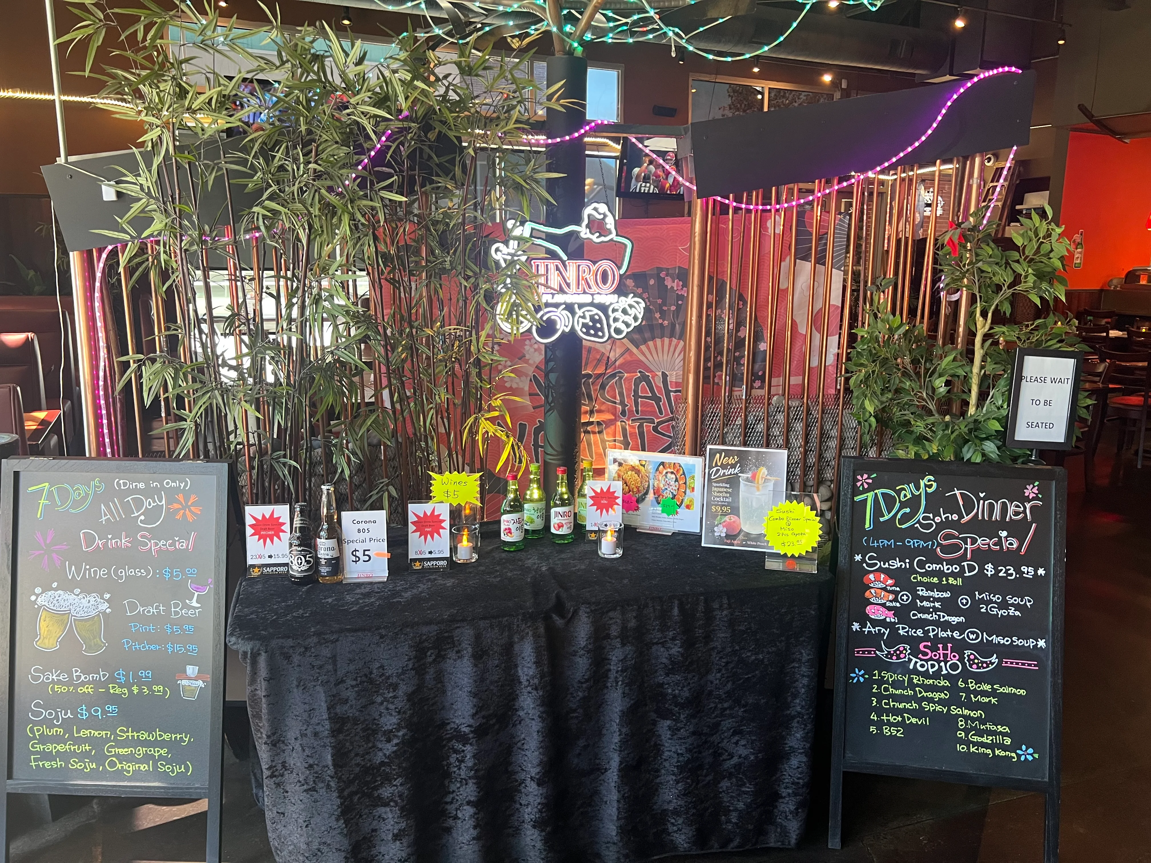 Cozy restaurant display with drink specials and sushi menu