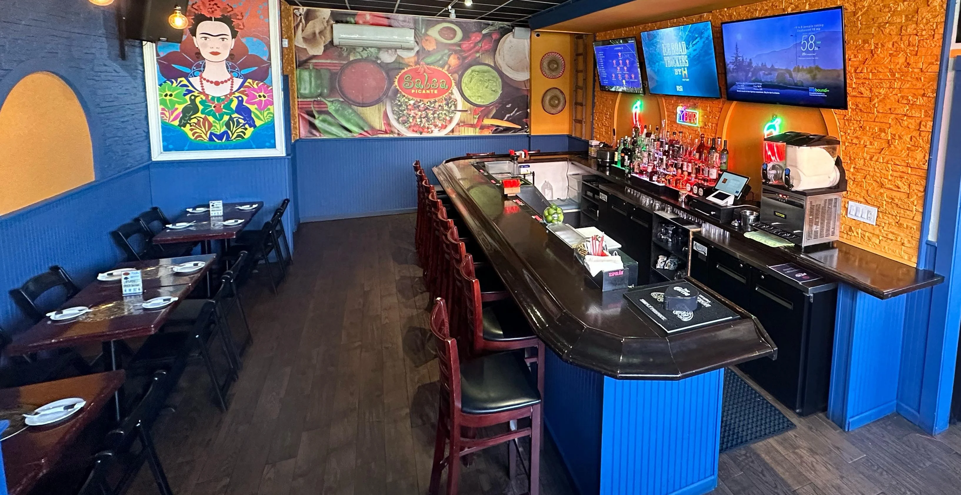 Vibrant restaurant interior with bar and colorful artwork