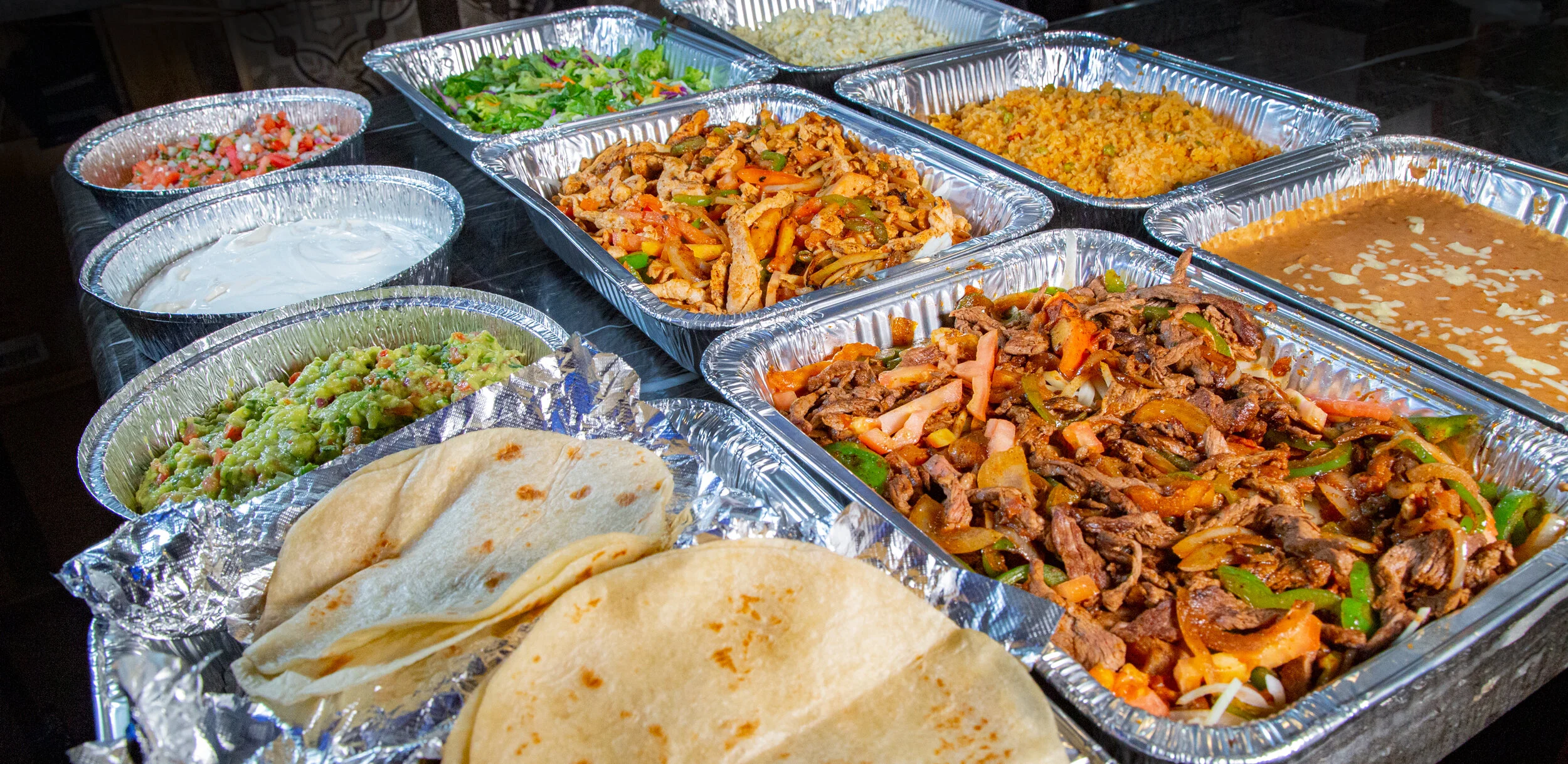 Mexican fajitas served with tortillas and sides