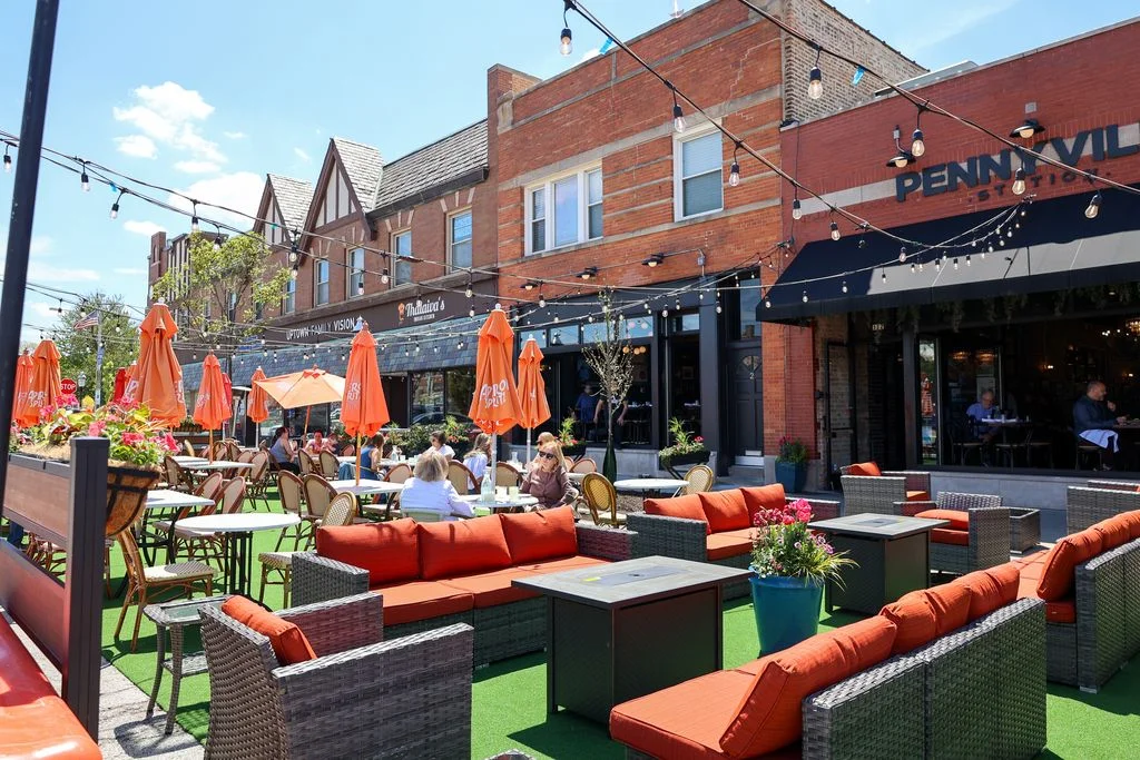 Outdoor dining area with vibrant seating and umbrellas
