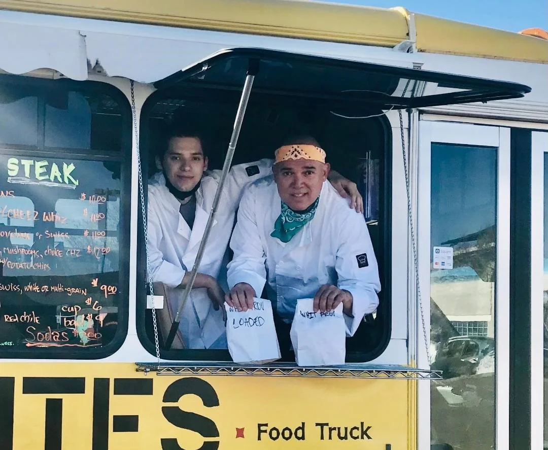 The owners Kyle and Rob standing next to each other in their previously owned food truck