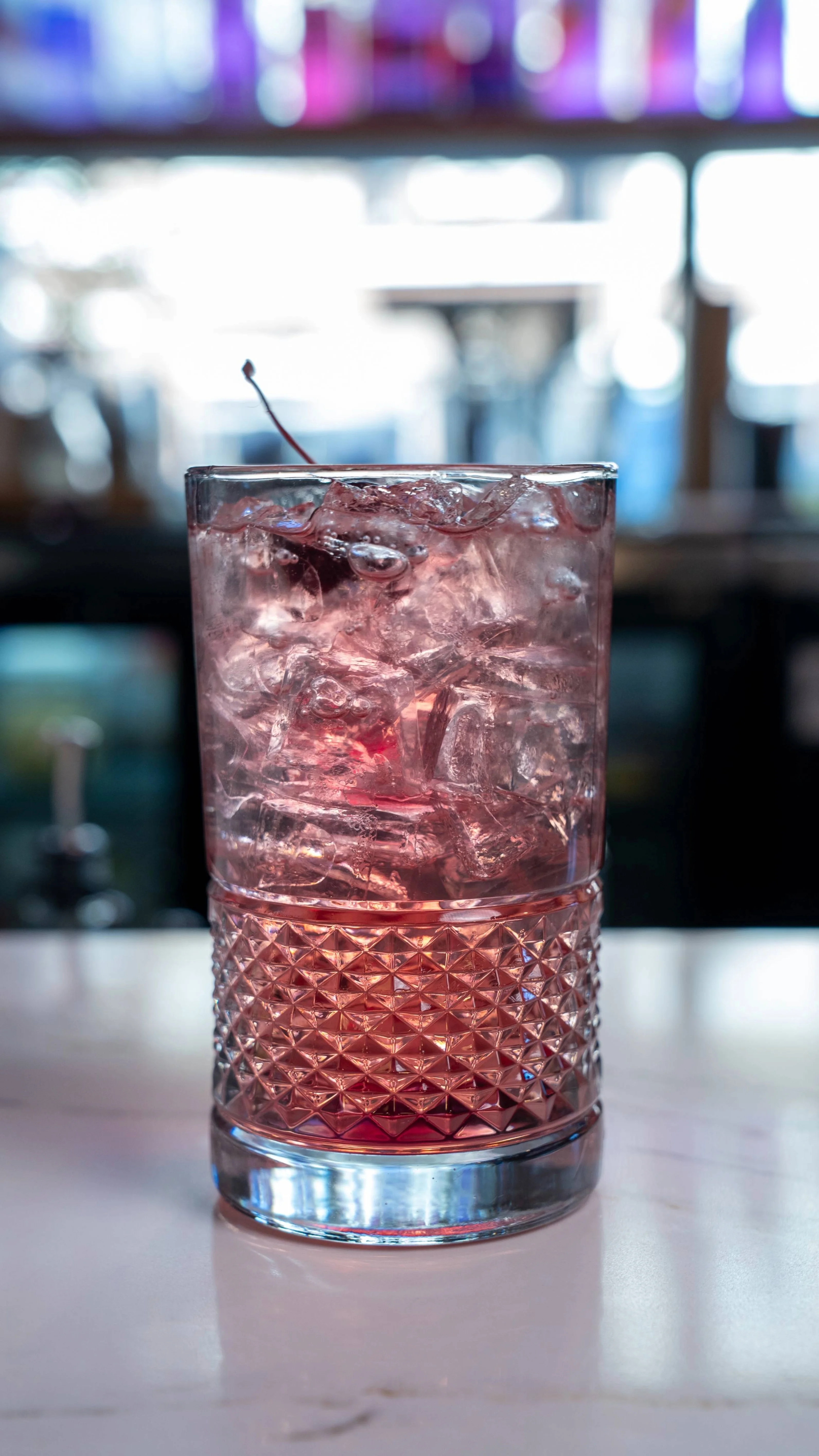 A refreshing Shirley Temple mocktail garnished with cherries and citrus.