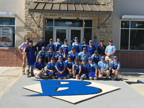 Team of restaurant staff in front of a family-owned establishment