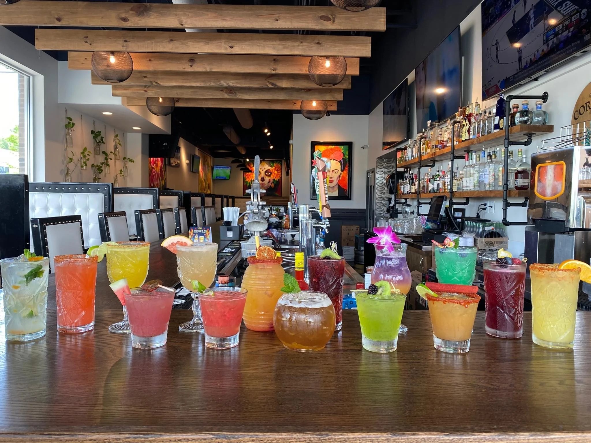 Colorful array of cocktails at a vibrant bar