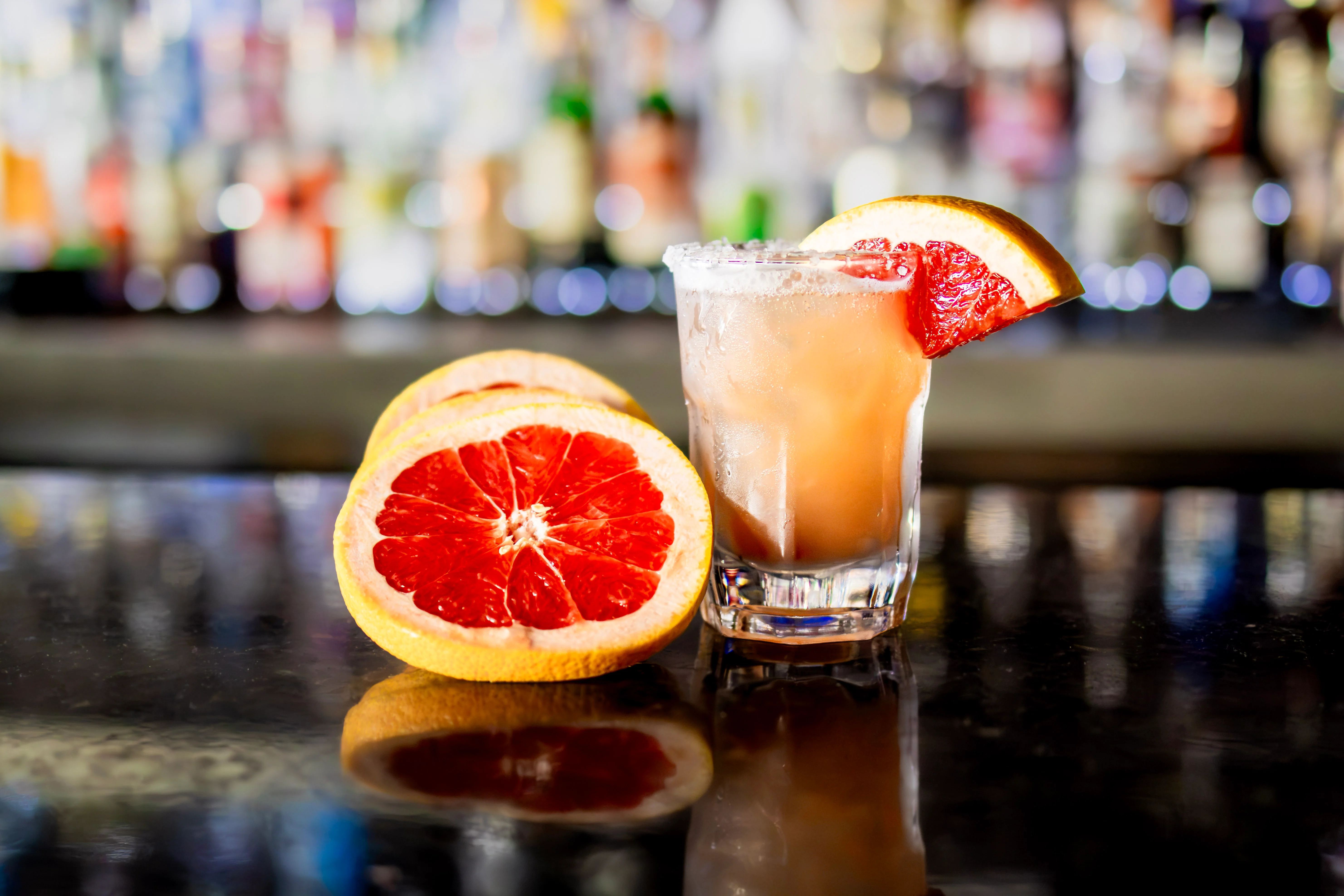 Refreshing grapefruit cocktail garnished with a slice, served in a glass