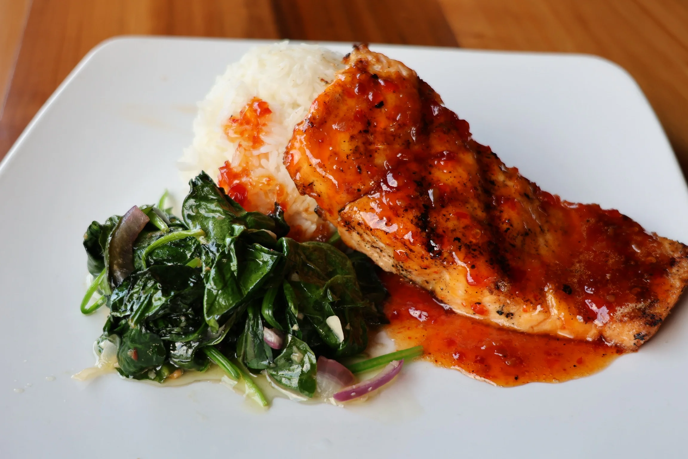 Grilled salmon with rice and sautéed greens